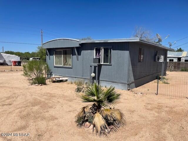 Well maintained single wide mobile home with 350 SF addition, fully fenced in the heart of Benson. Split floor plan with lots of storage space. Newer kitchen cabinets, counter tops and hot water heater. Furnace approx. 2 yrs. old. Fully fenced with doggie door and gated dog run. Easy access to Tucson. Cash only. Pot rack over island does not convey.
