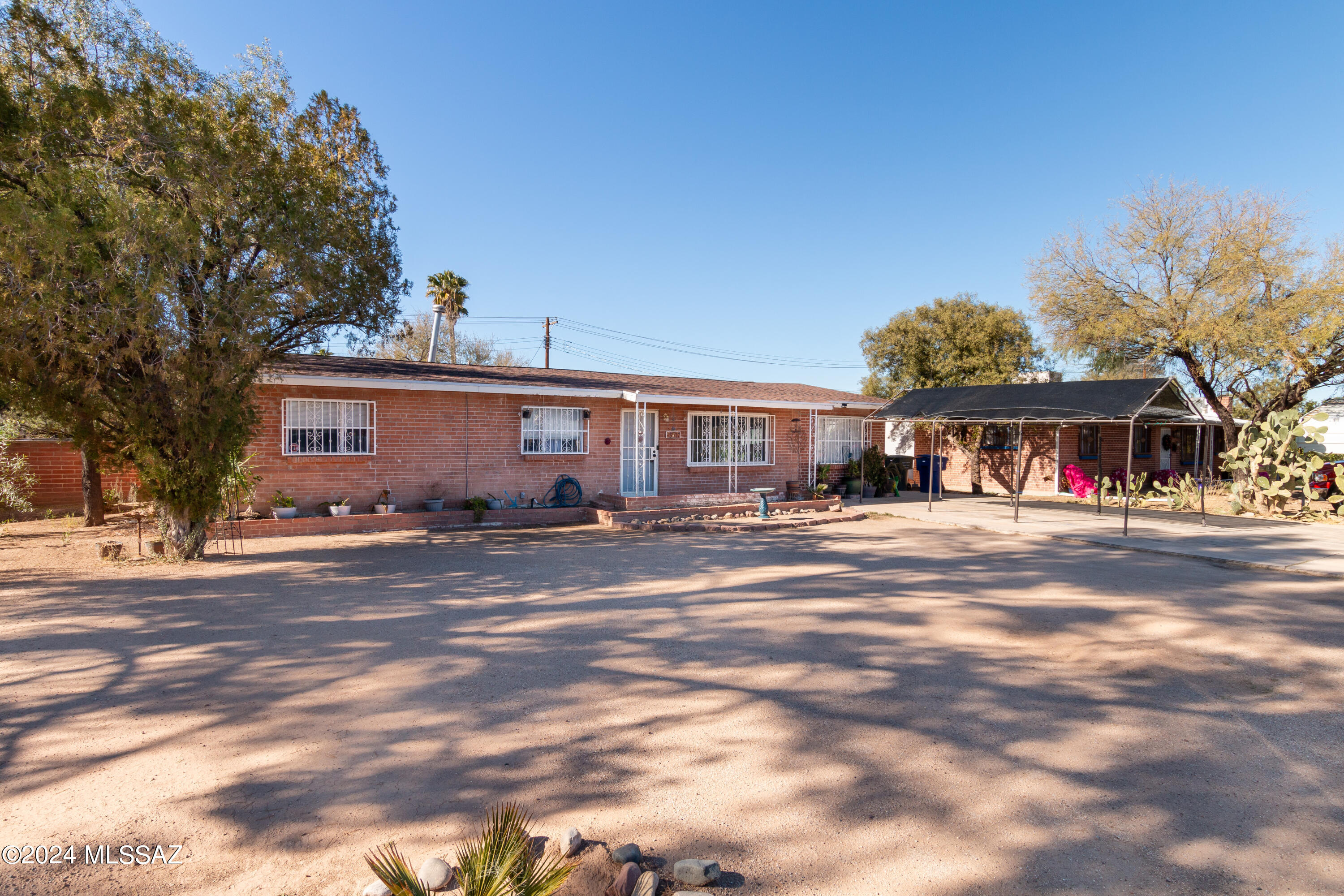 Investor dream!! Currently rented till August 2024 with rental rate of $2K per month.  Tenant agreement can be indefinite if Buyer wants. Charming brick home located in a small cul-de-sac community. 4 bedrooms and 2 bathrooms. Backyard has an expansive covered patio with a bonus storage/laundry room. Large front and backyard, with RV gate to access fenced backyard.  This home boasts a new water heater (2023), new patio glass sliding door (2023), newer A/C (2019), newer roof (2020), water line to street was replaced (2017). Great Central location! 2 blocks from Mountain bike path, 2 miles to U of A, close to shopping, restaurants, hospital, and River Walk! Buyer to verify all information.