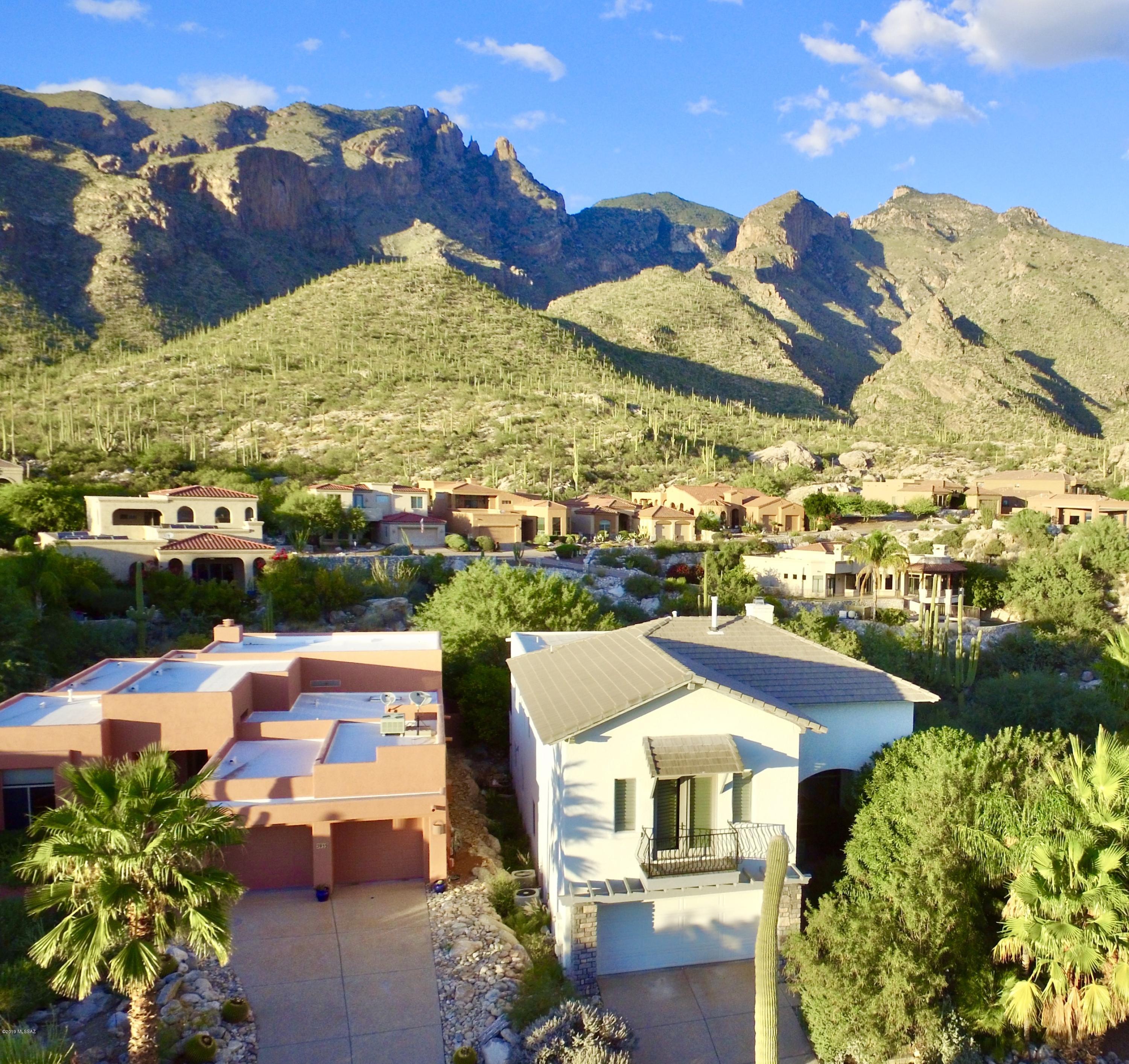 Stunning city views stretching to the Santa Ritas! Custom home high in the Foothills. Spacious living areas with soaring ceilings and wrought iron details. Floor to ceiling windows let in lots of light and views! Wood floors and travertine tile throughout. All bathrooms have been updated with granite counters and quality fixtures. Chef's kitchen with stainless steel appliances. Huge master suite with french doors and balcony. Luxurious master bath with jetted tub and walk-in shower. Backyard is quiet and private with gorgeous views of Finger Rock!