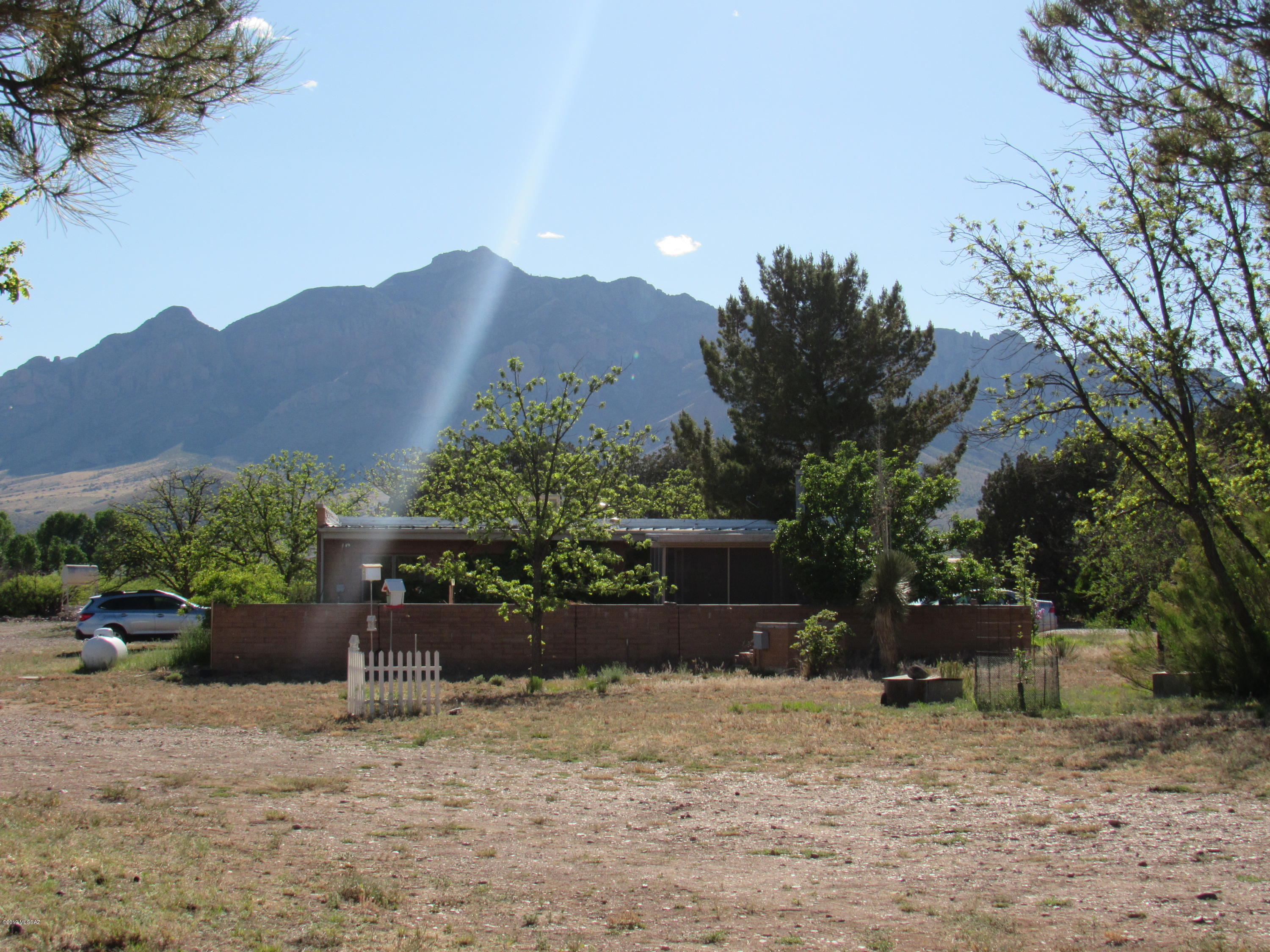 A birder's, artist, nature lover's desert oasis! 2 bed main home plus 1 bed guest house. Great opportunity to expand established B&B or perfect for a multi-family property. Includes 20 acres, orchard w/pecan, apple, & peach trees, several separately fenced garden areas, workshop w/electric & water, corral, barn w/tack rm, separate hay barn, 6 assorted storage sheds, plus shaded public bird viewing area. Main home has a wonderful AZ room &  walled backyard complete w/fountain/pond. Guest house has a welcoming back porch, w/its own small pond surrounded by mature pines. Easy access off paved Portal Rd. Spectacular 360° views of the Chiricahua & Peloncillo Mtns. Area is noted for it's dark skies. Only 5 miles to Portal with it's cafe/store, library, post office, medical clinic. Cave Creek Canyon begins around the corner world famous for its biodiversity, birding, & hiking. Additional adjacent acreage available.