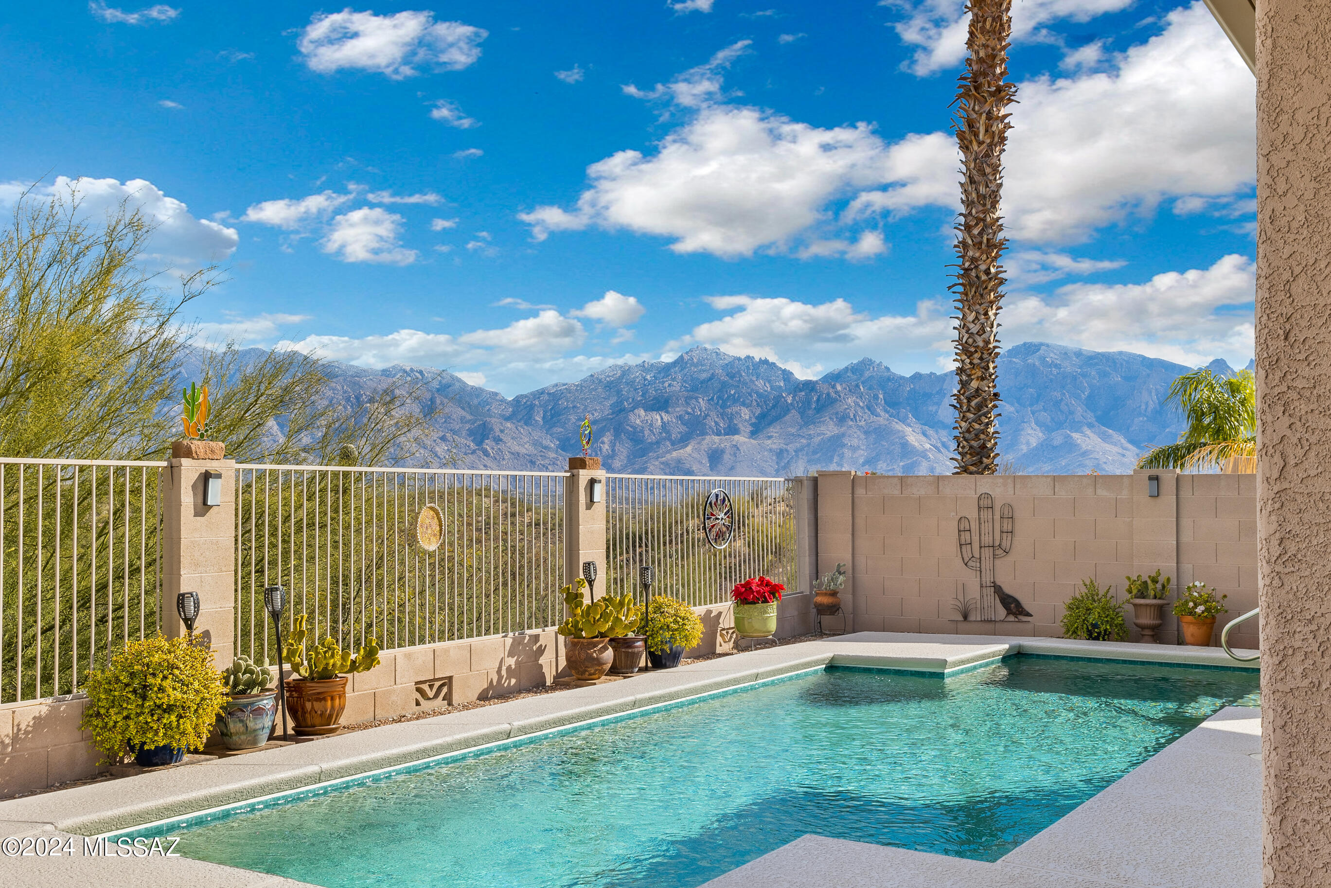 This location is SO hard to beat- nestled in an Oro Valley gated community on a dead-end street and backing to desert area with magical panoramic mountain views. Not only are there views from the back yard, but from the living areas and primary bedroom, too. The sparkling pool has solar heating coils and a variable speed pool pump (2019). There is a great room layout allowing fabulous entertainment space without being landlocked in the kitchen away from guests. A suite of black Whirlpool appliances were added in 2022. This immaculate single-story home has impeccable records of updates and improvements. Two-car garage iwith built-in cabinets, and a utility sink.  Furnishings package available.