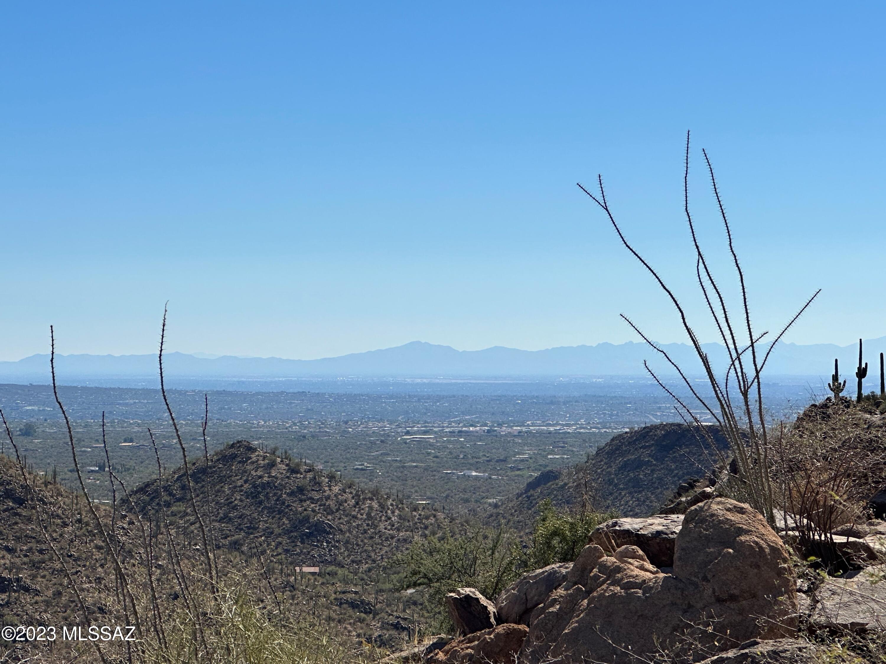 Sixty mile views of three mountain ranges, city lights set in the Tortolita Mountain range. Thru the tunnel one will discover the majesty of Saguaro Ranch /MOONLIGHT CANYON. Saguaro Ranch includes 1,200 acres and only 20% of the Sonoran Desert will be disturbed, 80% will remain natural Sonoran Desert in the Tortolita Mountain Range. Feel the privacy, tranquility, and security, yet all the conveniences of Oro Valley/Marana/Tucson have to offer and just minutes away. Championship Golf, 120 miles of cycling, walking trails in and around the greater Tucson area, and adjacent to Tortolita Mountain Park a hiker's dream paradise! Optional Clubhouse Membership would include neighborhood features, optional guest casitas and pools available. OPEN Tuesday - Sunday 12PM-4:30PM; Closed on Monday(s).