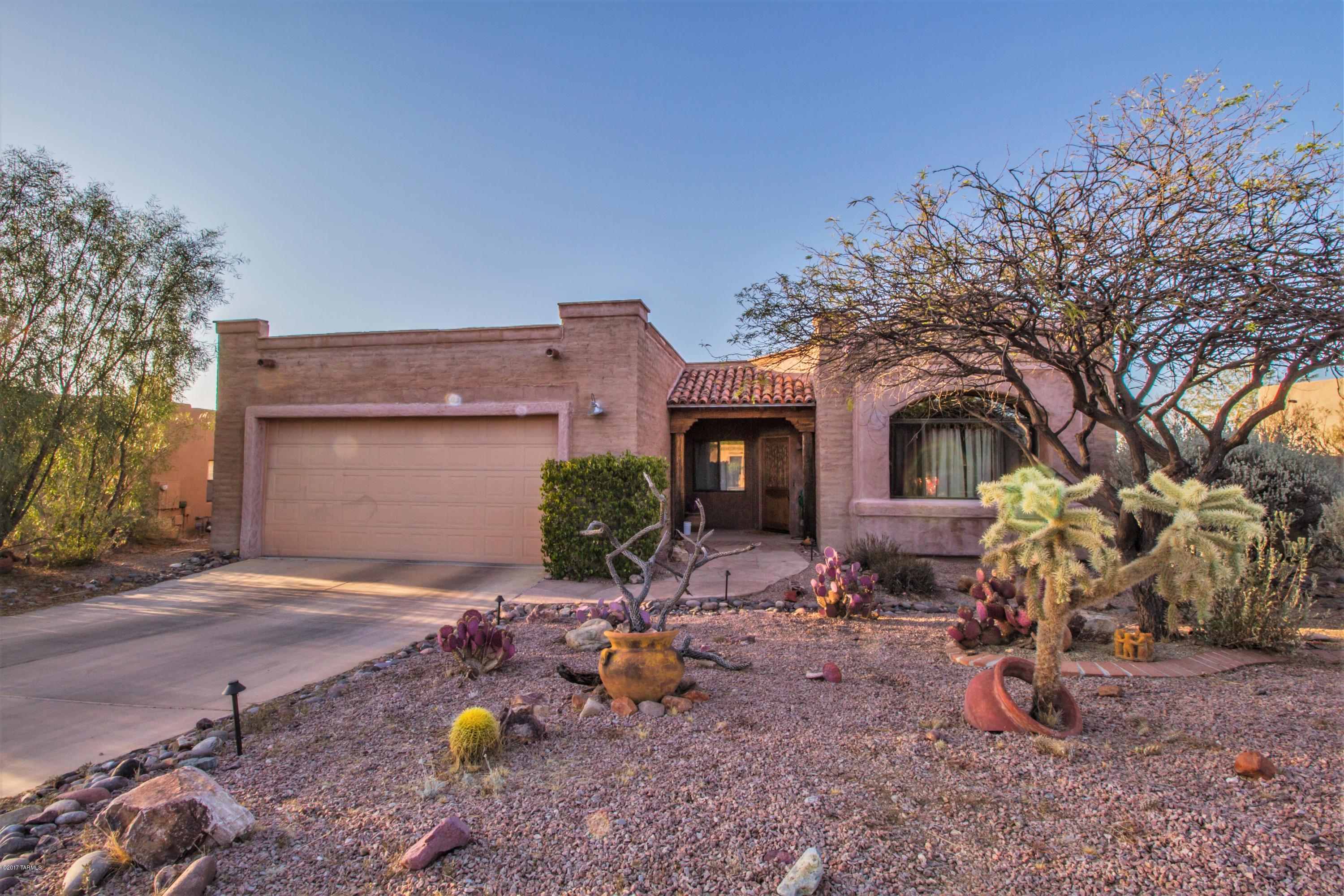 Stunning Southwestern home with tons of rustic charm! Home boasts designer paint throughout, lots of beautiful natural light, and desirable split bedroom floorplan! Gourmet kitchen features beautiful granite countertops, breakfast bar, under-mount sink, and upgraded fixtures. Cozy up to the fireplace in the bright and open family room! Great room boasts exposed beams, spacious dining area, and large arched windows! Three spacious bedrooms, including the master suite which boasts huge walk-in shower! Beautiful low care landscaping the in the front and backyards, large covered patio, and gorgeous views! This home is a must see!