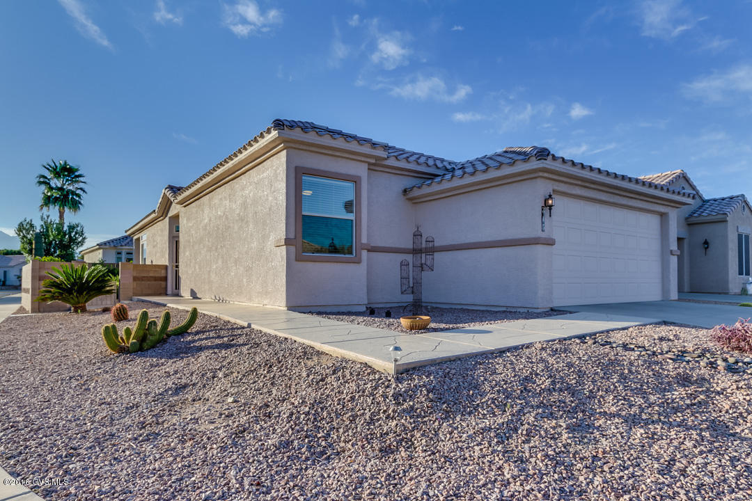 This is a beautiful 1279 Sq.' 2BR/2BA plus den home located on a lovely corner lot in the gated community of Sunrise Point. The home has attractive earth tone tile with sun shaped in-lay, soft blond cabinetry, and coffered ceilings in the dining area and master bedroom. The den is sizable with a bay window that allow lots natural light to flow in. The yard is nicely landscaped with scored concrete walks and patio spaces that offer partial mountain views alongside palm and fruit trees. The laundry room and extended garage finish this functional low maintenance property. This is a must-see home and great value!