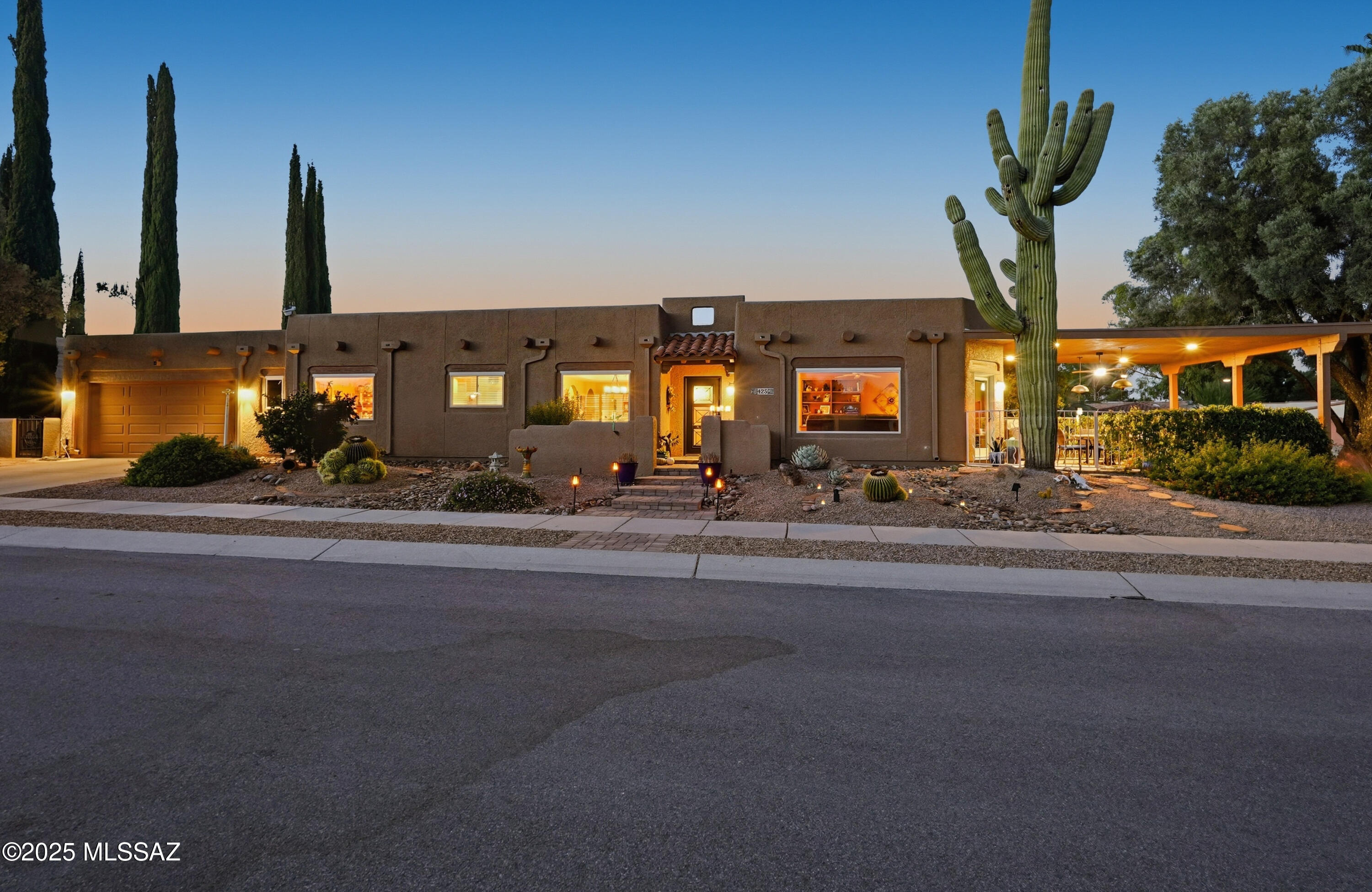 Nestled on a serene corner lot, this-one-of-a-kind townhome is a blend of desert beauty and thoughtful design. From the moment you arrive, you're greeted with natural desert blooms and a flourishing citrus tree. A true gem in Southern Arizona. Step through the designer front door and into the warm interior where rich tones set the stage for comfort and character. The cozy living room features a corner fireplace, built-in shelving and access to the private patio. The updated kitchen is a chef's delight, showcasing granite countertops, stainless steel appliances, pantry, cabinetry with pull-outs, and three lazy Susans. A sunlit breakfast nook adds a cheerful touch. The dining area is a stunning blend of rustic ambience. A large picture window frames the natural beauty outside. Bold rustic beams and a tray ceiling embellished with kokopelli accents create an open feel with Southwest charm. The Primary Suite offers a row of windows, double closets, and updated flooring, while the en-suite bath boosts a walk-in shower with a Rainforest Shower Head with temperature sensors and a Spa Shower Tower, raised cabinetry with dual vanities, updated lighting and walk-in closet. A versatile bonus room-ideal for an office or den-connects to the hallway via double doors and an extraordinary atrium that floods the space with natural light. Guests will feel right at home in their private retreat, complete with its own cozy patio. A highlight of the home is an expansive covered patio, an ideal spot to take in the gorgeous mountain view. Blooming vines cascade along its edges, adding a burst of color and a touch of tranquility. This inviting outdoor space blends beauty with a peaceful seclusion. Enjoy peace of mind with newer exterior paint, energy-efficient Anderson windows, and a whole home filtration system. The two-car garage offers an abundance of storage and a work bench. This townhome is truly a standout!