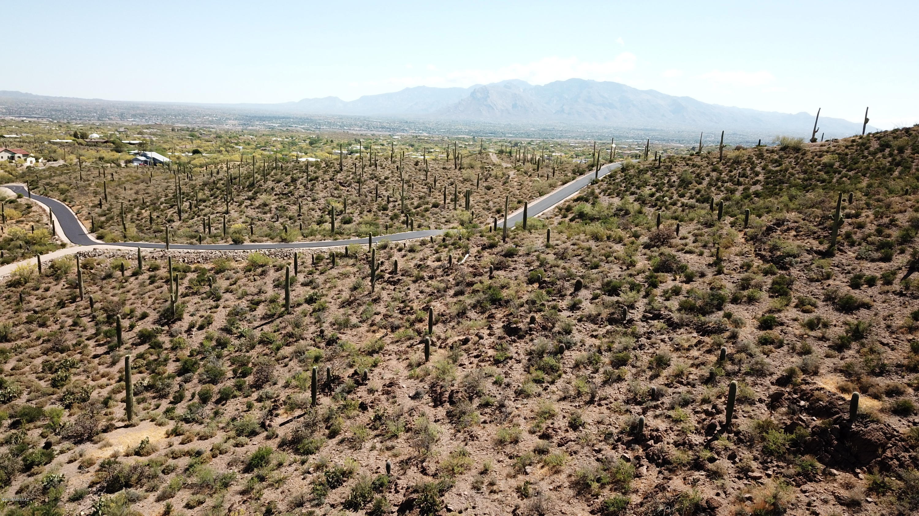 Small enclave of spectacular lots with dramatic city and mountain views. Located where the Tucson Mountain foothills begin their gentle rise above the valley floor. Short private road with beautiful gated entry in an area of new custom homes. Majestic saguaros, easy access to I-10, downtown and shopping. Perfect for your custom home, builder services available. Two principals of the owning LLC are licensed to sell real estate in Arizona. Sensible deed restrictions.