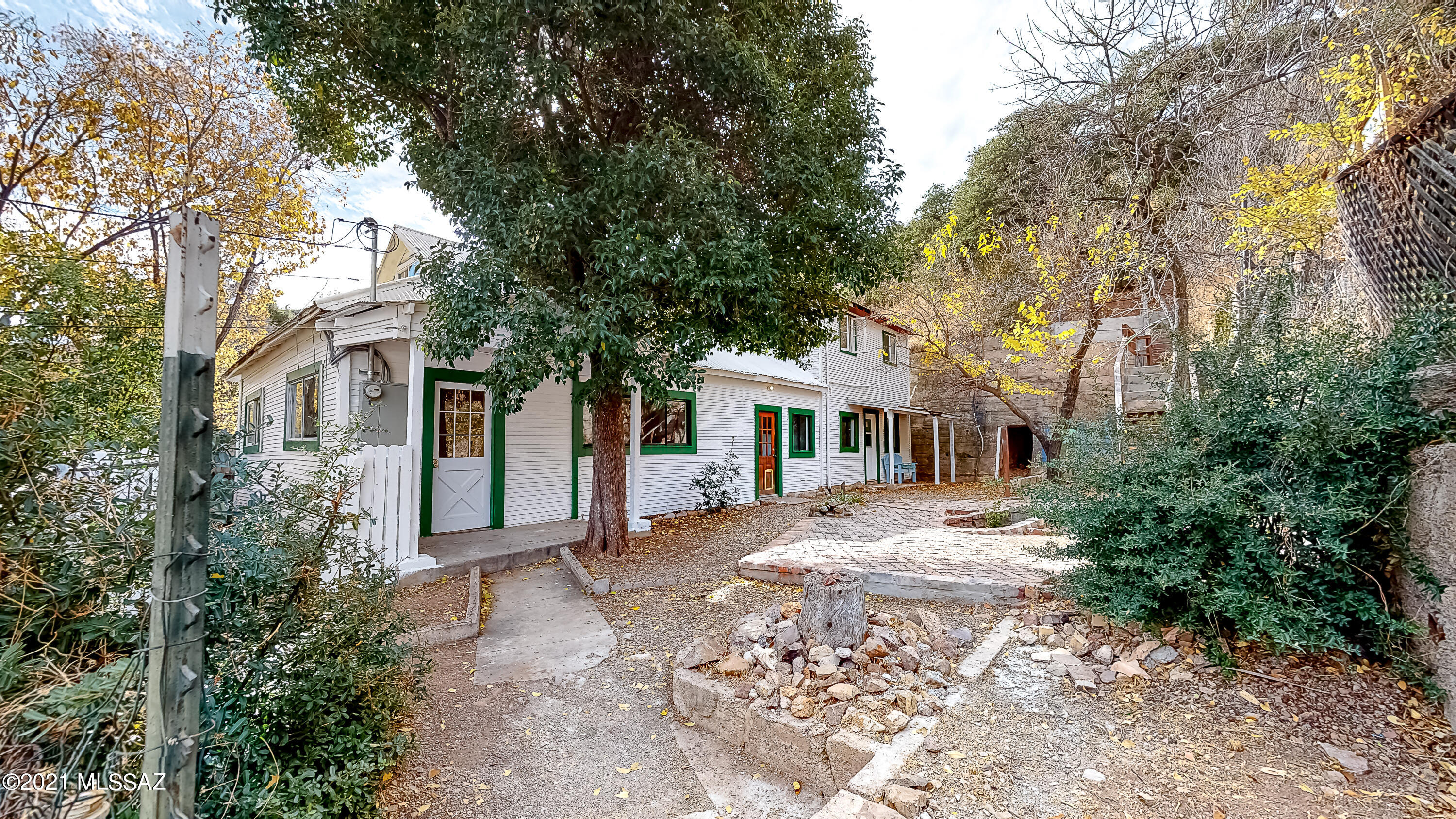 Classic Old Bisbee home sits at the top of dedicated easy climb stairs that open to a beautiful courtyard. Tons of room indoors & out. Secluded & private, 1,785 sq ft of living space in this 4 bed 2 bath home with mostly finished 3rd-story storage attic. Large two-level 7,504 sq ft lot. So many possibilities with this unique home. 2 kitchens & 2 separate living areas with private entrances. Can be a duplex, live on one side & rent the other, or open it up & use as one large home. Much of the heavy lifting has been done - updated electrical panel, plumbing, & gas lines. At 117 yrs old, this home is a sound fixer upper & is sold As Is. With your upgrades & finishing touches a lot of equity is still to be realized in this great home. Motivated Seller, Make it your home today!