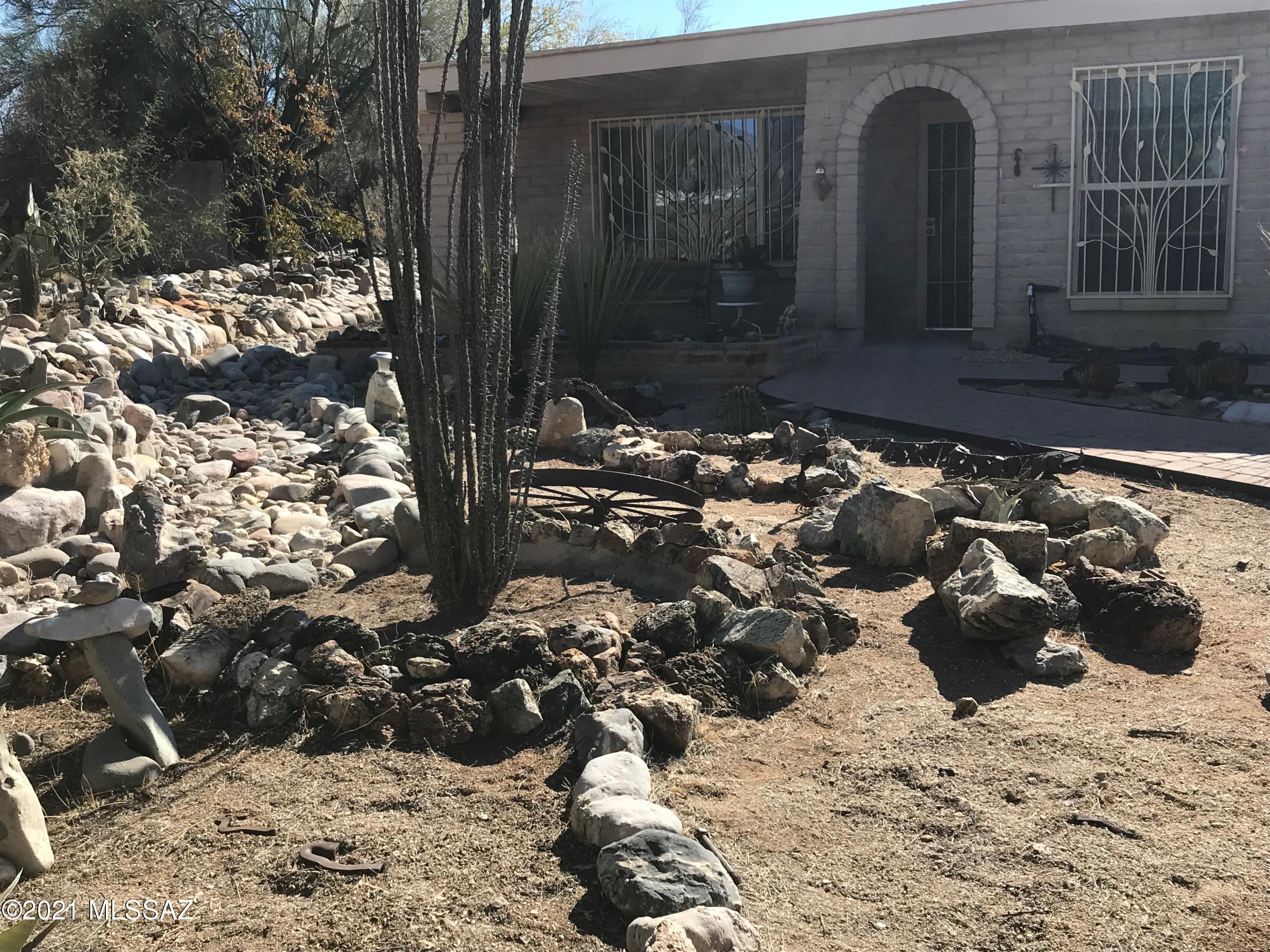 this semi-custom 4 bedroom north east home offers so much. Ceiling fans all 4 rooms, 3 bathrooms, 400 sq ft  entertainment wet bar with covered area for freeze/ refer, water for Ice maker, 2 closets, reinforced mounting for large TV, soundproof in all walls bordering house.Family room w/fireplace.  fake dog house conceal. 2 car garage wi/insulated door, 220v outlet. 3 car walled carport (totally shaded). 160 sq. ft. workshop 220v outlet pegboard shelving and workbench. walled back yard with  metal riser for additional security/privacy/pets. 19,000 gal swimming pool with diving board. Pentair Superfllow VS multiple speed pool pump w enclosure, pentair Triton TR60 sand filter, Kreepy Krawly all new 2016. water capture, 12x16 Ramada, granite kitchn counters custom pullout cabs/full range.