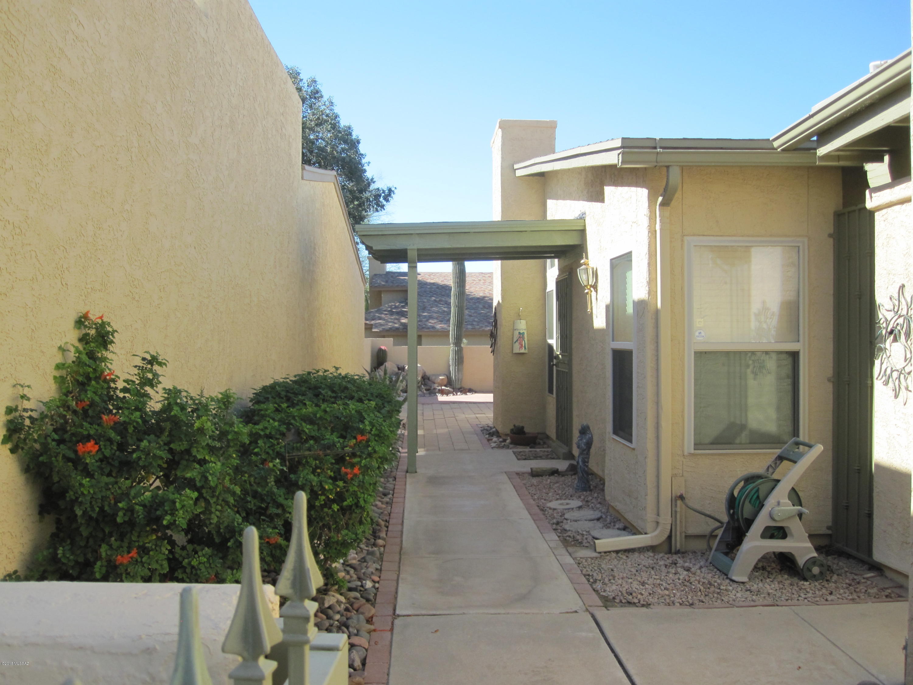 Light and bright with high ceilings, this patio home lives larger than the square feet. There is wood look laminate in all the high traffic areas and a split bedroom floor plan. Third bedroom is currently used as an office and the safe will convey. The kitchen has newer cabinets and opens to the living area.  Current owner has installed an Ecosmart instant water heater with a scale buster for quick hot water delivery. Located close to the common area pool and spa.  Easy maintenance. All applicances convey.