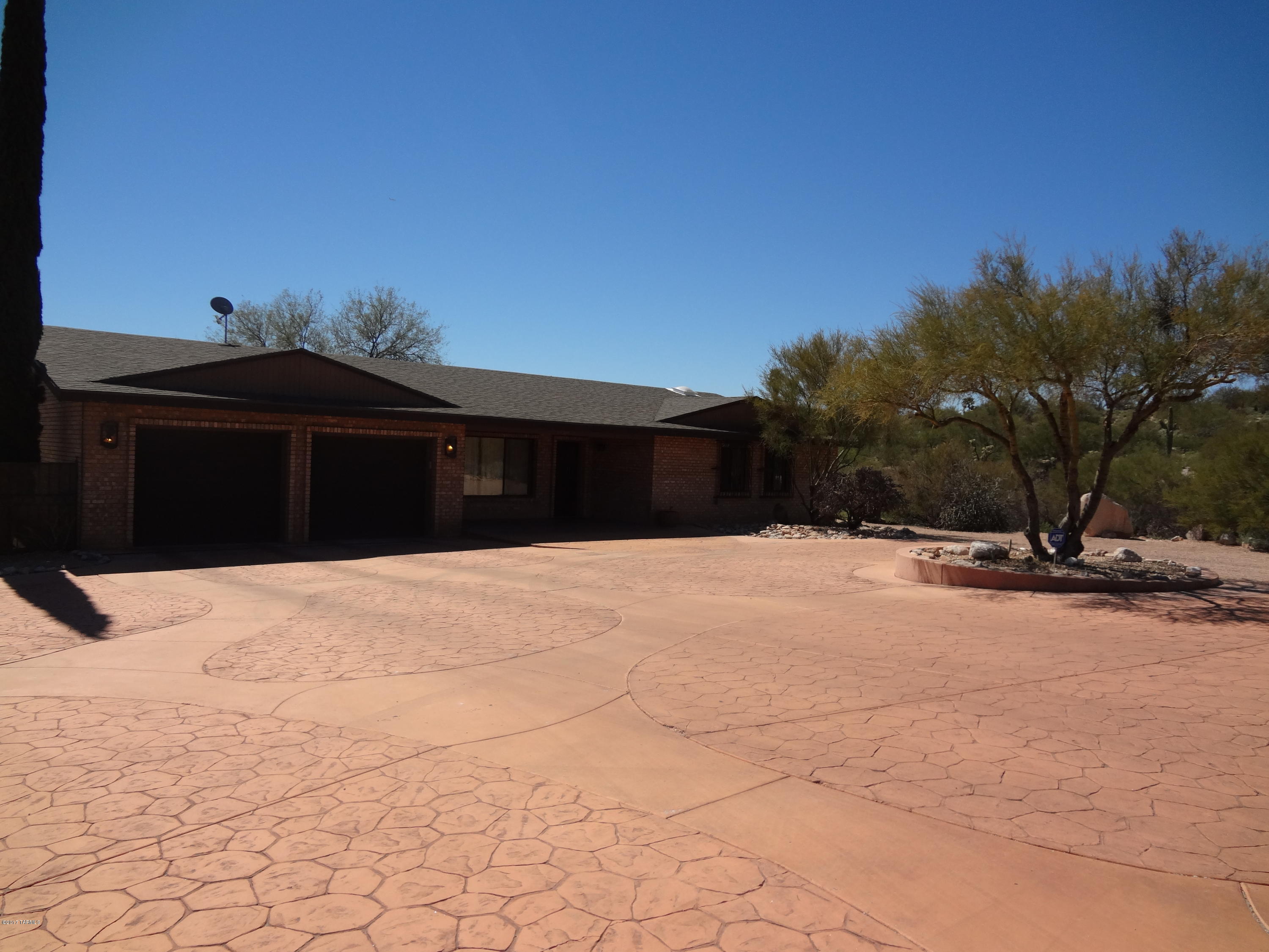 Price Reduced!  Come check out this one and half acre lot! This beautifully appointed home has gorgeous city and mountain views and is located  in desirable Catalina Foothills School District. Luxurious master suite with walk-in closet and huge bathroom.  Some other features include: open floor plan, spacious living area, a fireplace, breakfast bar, upgraded stainless steel appliances, gas double oven, a 2 car garage, carport, and workshop. From the large covered patio enjoy views of mature vegetation, grass, separately fenced pebble-tec pool w/ramada and a new built-in bbq grill.