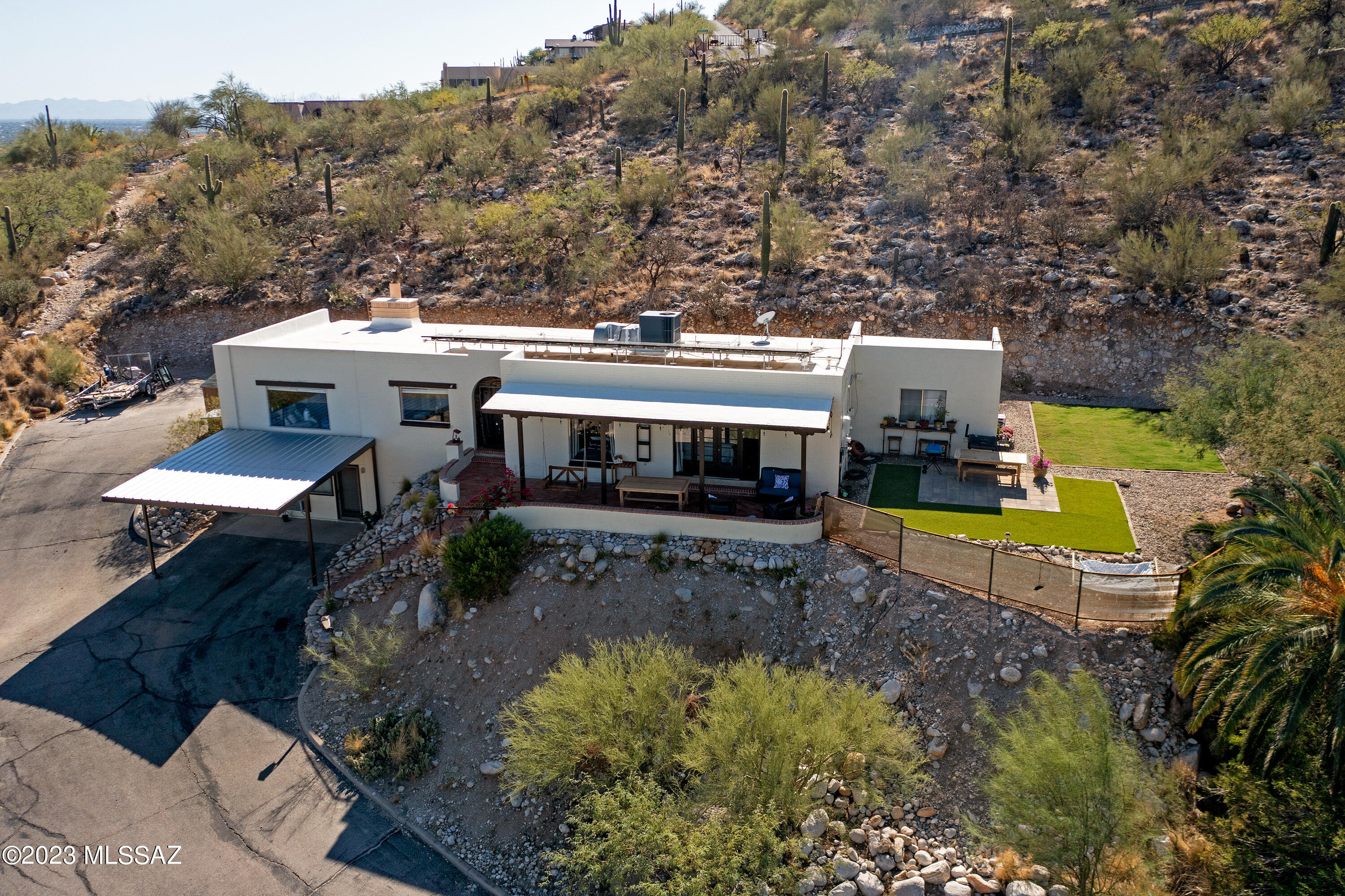 Experience awe-inspiring vistas of mountains  on this secluded 1.3-acre cul-de-sac property. This charming 4-bedroom, 4-bathroom John Wesley Miller home has been thoughtfully renovated. Featuring expansive windows in the dining and living areas to capture the stunning scenery. Revel in the custom-built cabinetry, stainless steel appliances, and a gas stove in the well-appointed kitchen. The living area boasts a magnificent stone fireplace, complemented by exposed beam ceilings and ceramic tile flooring throughout. The spacious primary suite offers dual vanity areas and French doors leading to a brick patio/balcony with panoramic views. Additionally, you'll find a generous guest suite with a private entrance, kitchen, and bath—an ideal space for in-laws, teenagers, or rental income.