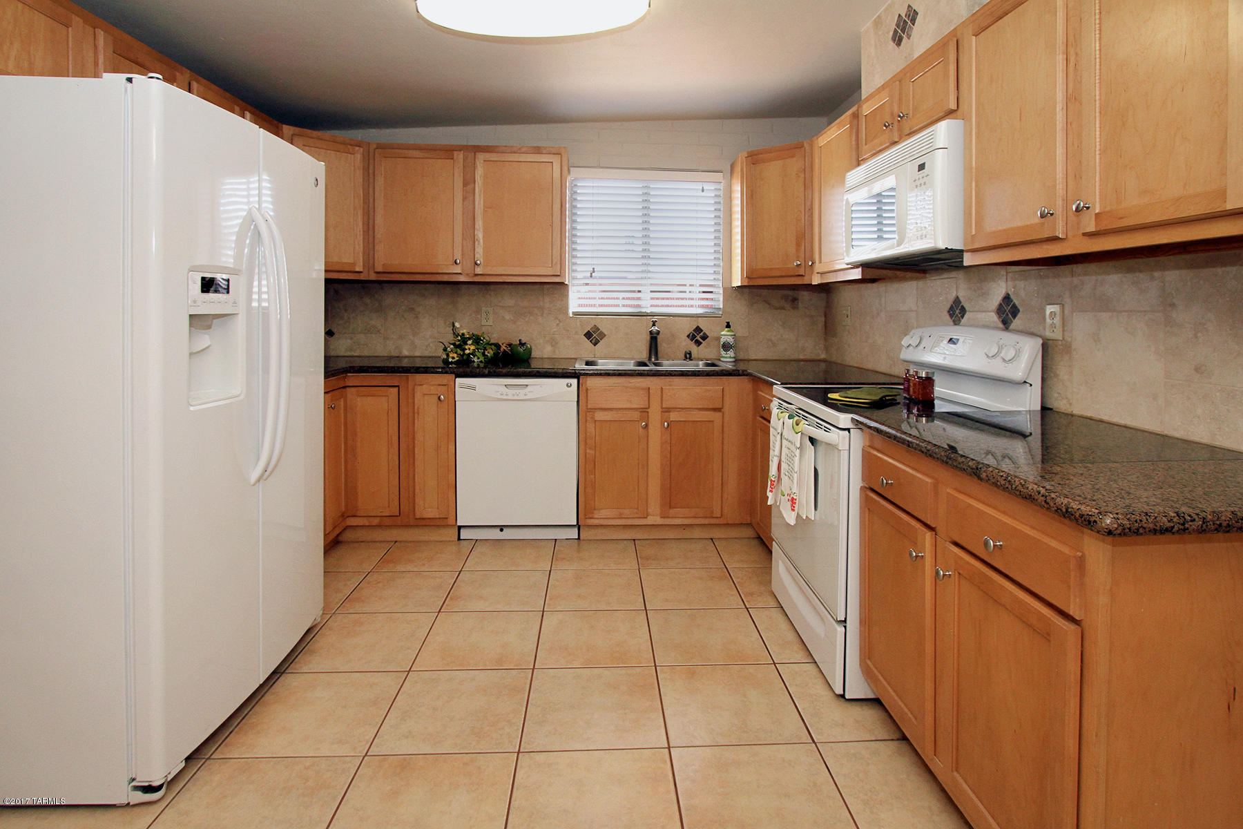 Beautiful updated home on large private lot.   3bd 2ba spacious remodeled kitchen with lots of cabinets and storage space, pullouts and lazy susan.  Granite countertops and stone accents to compliment the space.  Laundry closet with full size washer and dryer, new fixtures throughout this lovely home.  Fresh painted walls with pleasing neutral colors. Huge back yard.  Great park just steps away.  Home warranty included.  This is a MUST see.  Pride of ownership shines in this updated beautiful home.