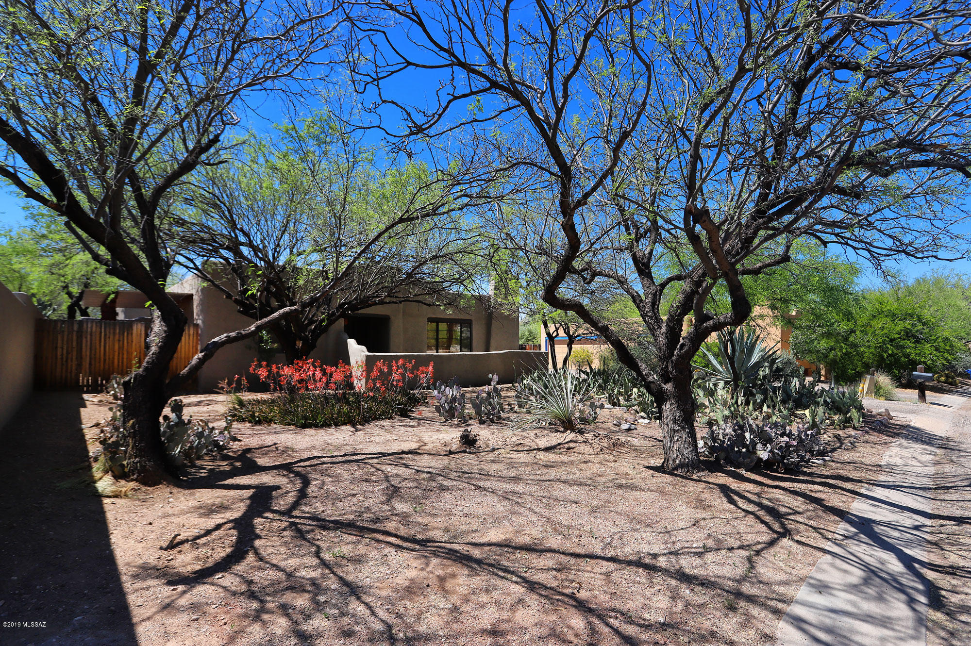 Located in a small enclave of Santa Fe style homes that rarely come on the market, this charming property is sited on a desirable interior lot. Features include a beehive fireplace in the family room, saltillo tile throughout, master bath with private patio area, new garage door, and freshly landscaped backyard with large covered patio. Conveniently located very close to the Loop, Trader Joe's, the farmer's market at St Philip's, and the Mountain Ave bike path!