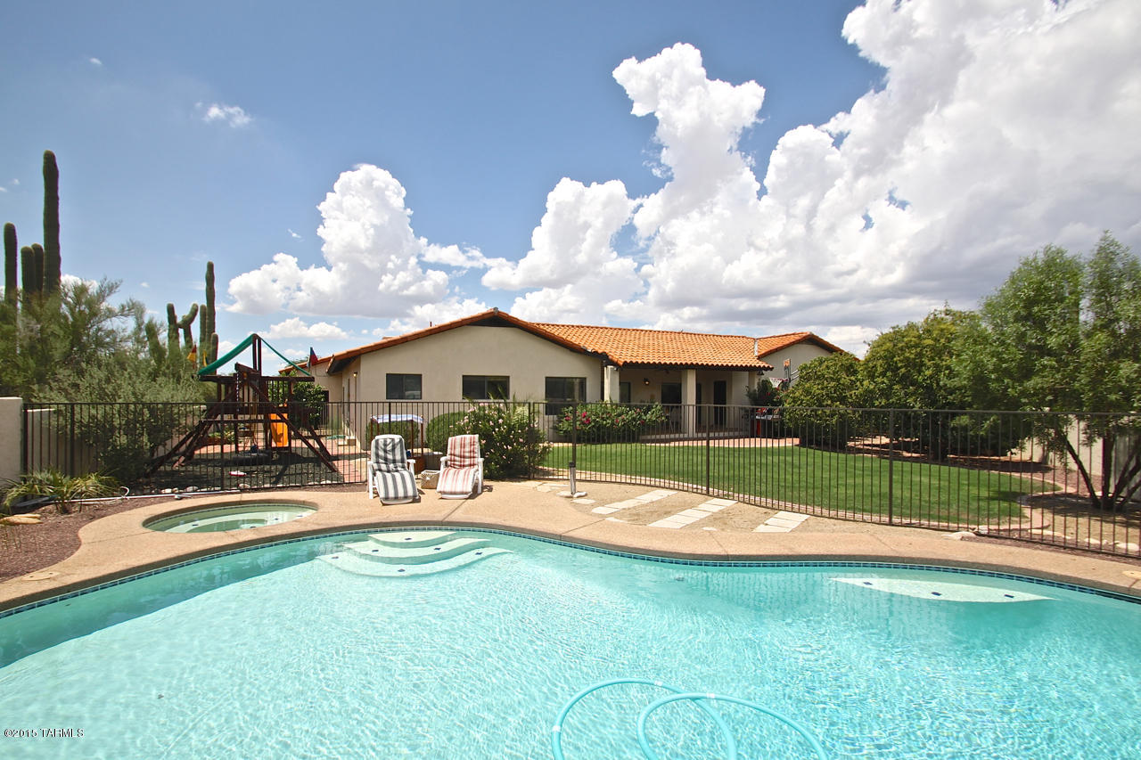 Large 4 BR Hm tucked away in a quiet area of Shadow Hills; Pool, Spa & Grassy play area w/ Mountain Views; 16x25 Basement for Storage, Craft or Play area & 12x24 Exercise/Workshop (off garage) w/ A/C, Both not included in S.F.; Huge 19x25 FRm w/ brick Fireplace; Guest BR Suite has Private 3/4 Bath & Private Patio; Kitchen, Master BA, Hall & Guest Bathrooms recently remodeled; Master Bathroom w/ Quartz counter; Kitchen w/ new KraftMaid Birch Cabs & Granite counters; Newer Carpet in LRm, FRm & MBR; Wood Stained Interior Doors & Trim; Courtyard Entry w/ Fountain; French Door Refrig included; Zoned A/C; 80 Gal Solar H/W Heater w/ Elect Backup & Recirc Pump to Kit; PV Solar System reduces Electric Bills; Central Vacuum; Ceiling Fans; RV Parking in back of oversized Garage; 7 Mature Citrus Tree