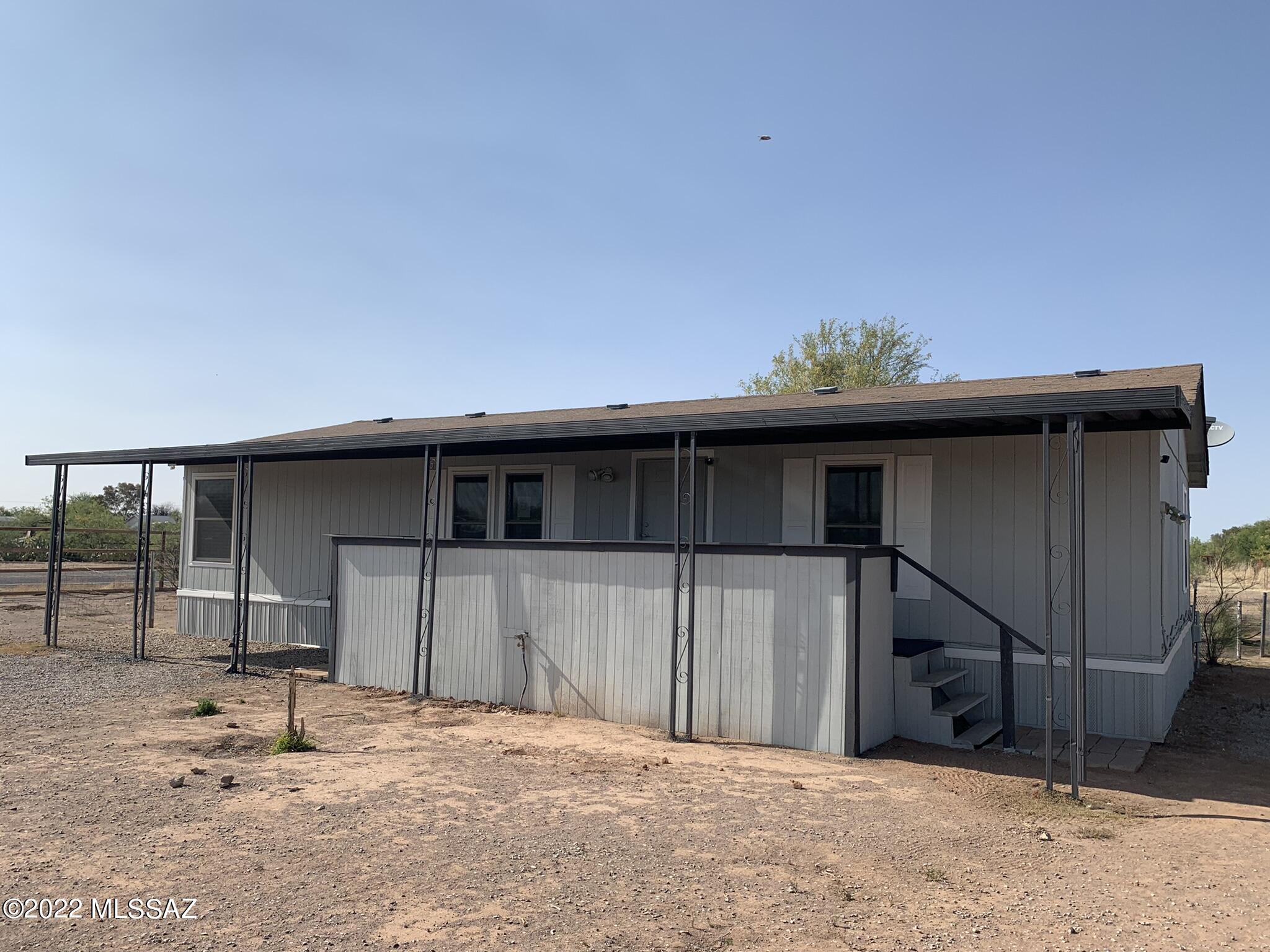 Bring your RV, your toys, your horses and family!  Peaceful, rural living on this clean 1 acre fenced lot with room for everything.  This affordable split bedroom home has been painted inside and out, has new carpet and wood laminate floors in wet areas.  The porch steps (front and back) have been rebuilt too.  Double gate entry to the front and through the side for those big rigs or RV's. A good sized storage building in the back can hold and protect all of your tools.  Refrigerator, washer and dryer all convey.  Come experience the peace and quiet away from the hustle and bustle.
