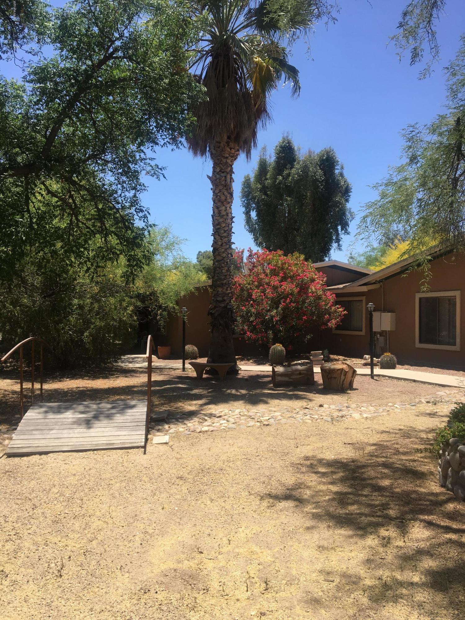 This a great buy 2 houses for the price of one!  Main house has 5 bedrooms/2 baths 3525 sq ft,, second house has 4 bedrooms 2 baths 1600sqft, Separate Meters and Septics. Plus 3 covered patio's 3 sheds+ covered carport/workshop with 220 electric.Great pool! 6 free standing awning's. Set back from Tanque Verde with many trees. So much privacy