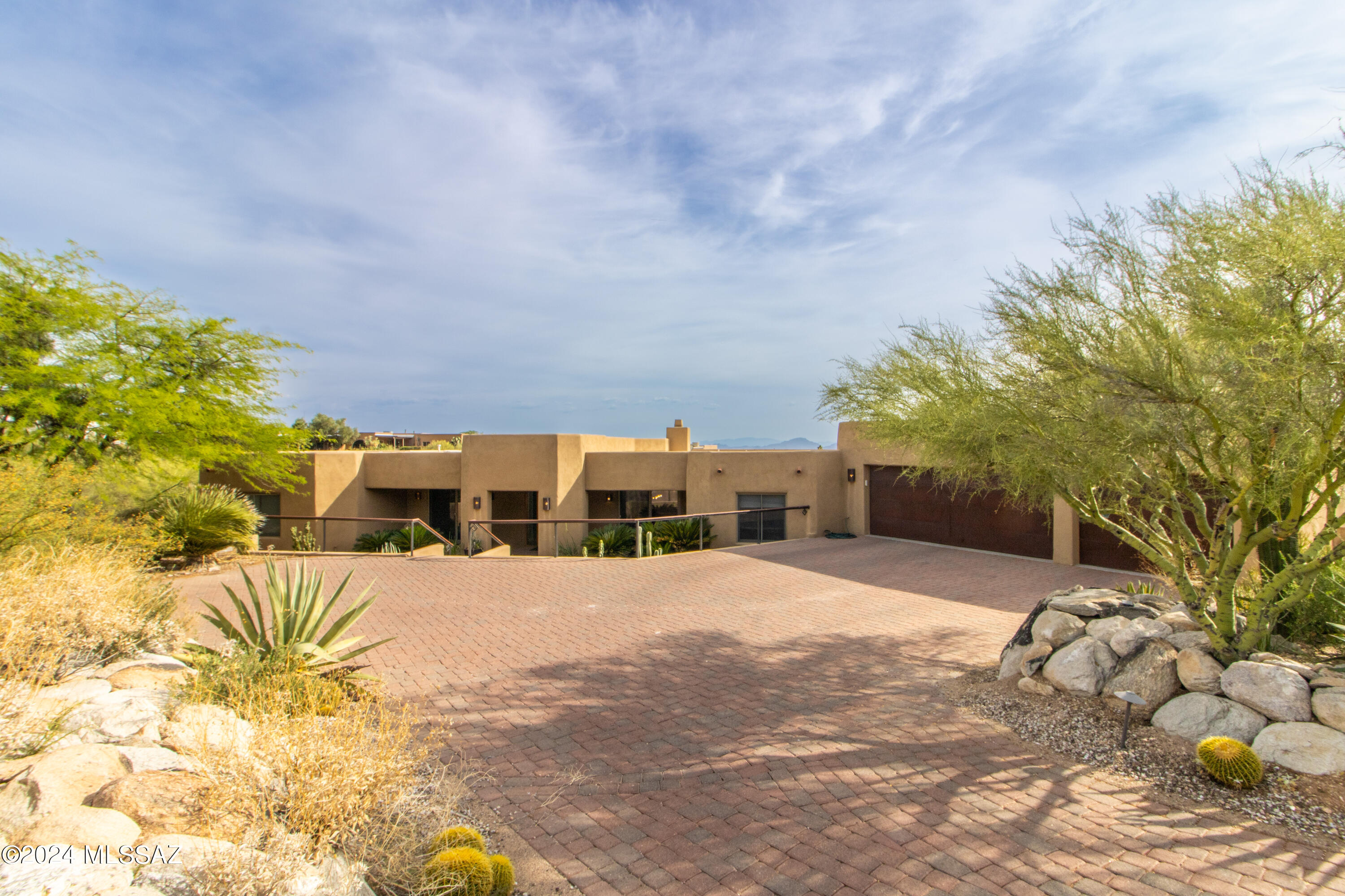 Stunning contemporary home located in exclusive, gated Pima Canyon Estates. Gorgeous city & mtn views. Incredible kitchen w/ leather granite waterfall island, breakfast bar, custom cabinets, modern backsplash, SS Viking appliances including 6-burner gas stove & dbl ovens. Kitchen opens to family rm w/FP & breakfast area & flows to the back patio w/city views. 4 Bedroom/4.5 bath, 3 of the bedrms are en-suite.Spacious master suite & bathroom w/travertine tile, garden tub & walk-in shower. Formal dining rm off of kitchen w/beautiful views & formal living area w/new wall of windows to capture views. Lg laundry rm w/storage & sink. Travertine flrs thruout. Pool/Spa & outdoor BBQ, 3-car garage.
North/South exposure lends itself to the indoor/outdoor lifestyle in the desert. Entertainers patio to view city lights.
1 yr Lease, $7500 Rent, $5000 Security Deposit, $500 cleaning Fee
Call to schedule a showing today!