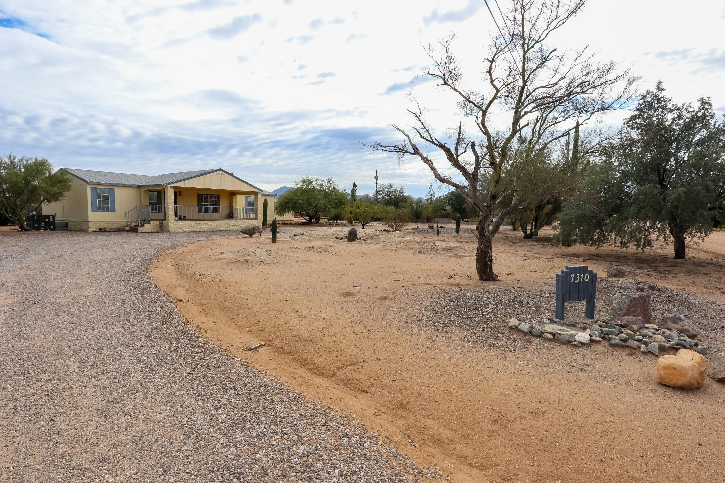 This property won't last long! Furnished home! Situated on over an acre lot that is fully fenced on the back side of property. Large composite deck out back. Amazing front porch with brick pavers, split faced columns and custom rod iron surround. Beautiful circular driveway with plenty of saguaros! Great little workshop! Nicely size rooms, and a Split floor plan. Make this your home today!