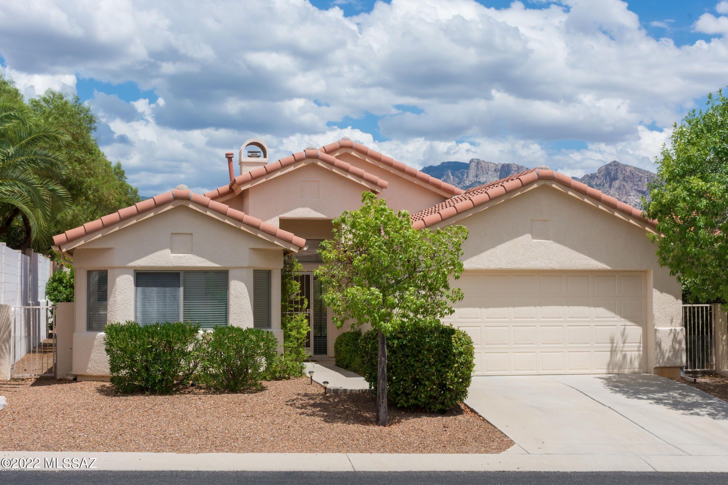 Beautiful 2BD/2BA + Den (1,642 sq ft) home in desirable Canada Hills w/views of the Catalina Mountains & backs up to common area. Split floor plan with high vaulted ceilings throughout. Gas fireplace in the Great Rom. Formal Dining off Kitchen. Spacious Primary BD Rm, plus bathrm with w/double vanity, a large closet, a large walk-in shower. Guest Bedroom hosts lovely bay window. Guest Bathroom highlights double vanity, shower/tub combo. Nice sized den would make a great office or sitting room. $5000 flooring CREDIT to Buyer with reasonable offer.  2-Car Garage w/built in cabinets for extra storage. Enjoy picturesque Catalina Mountain & desert views from the landscaped backyard. Refrigerator, Washer & Dryer are included. Located in the heart of Oro Valley w/ close access to library, parks and amenities.  Come take a look!