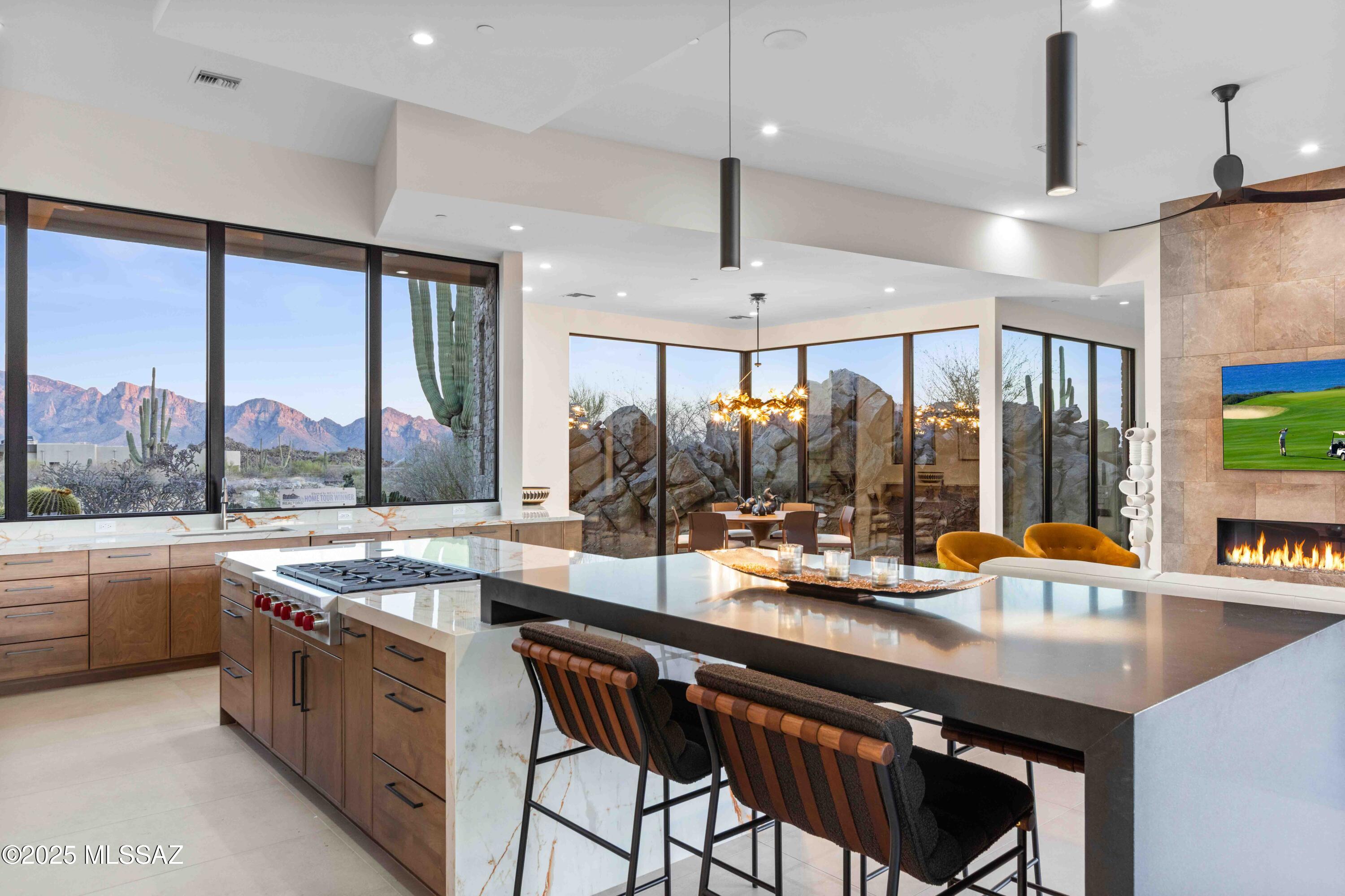NOW OFFERED FULLY FURNISHED Escape the ordinary on this remarkable homesite surrounded by stunning rock outcroppings and soaring saguaros.  Perched high on the hilltop in the prestigious Stone Canyon community, this Marc Soloway Design was meticulously created to merge the tranquility of the desert scenery with the functionality of indoor/outdoor living.  A seamless transition featuring 30' walls of glass that highlight the expansive views of the Catalina Mtns towards the front of the house, while maintaining the utmost privacy in your secluded, backyard oasis which backs up to the Pima County owned 3,100-acre Tortolita Mountain Park.  This 4,033 sq ft home offers a split, four bedroom plan with a flex room and a