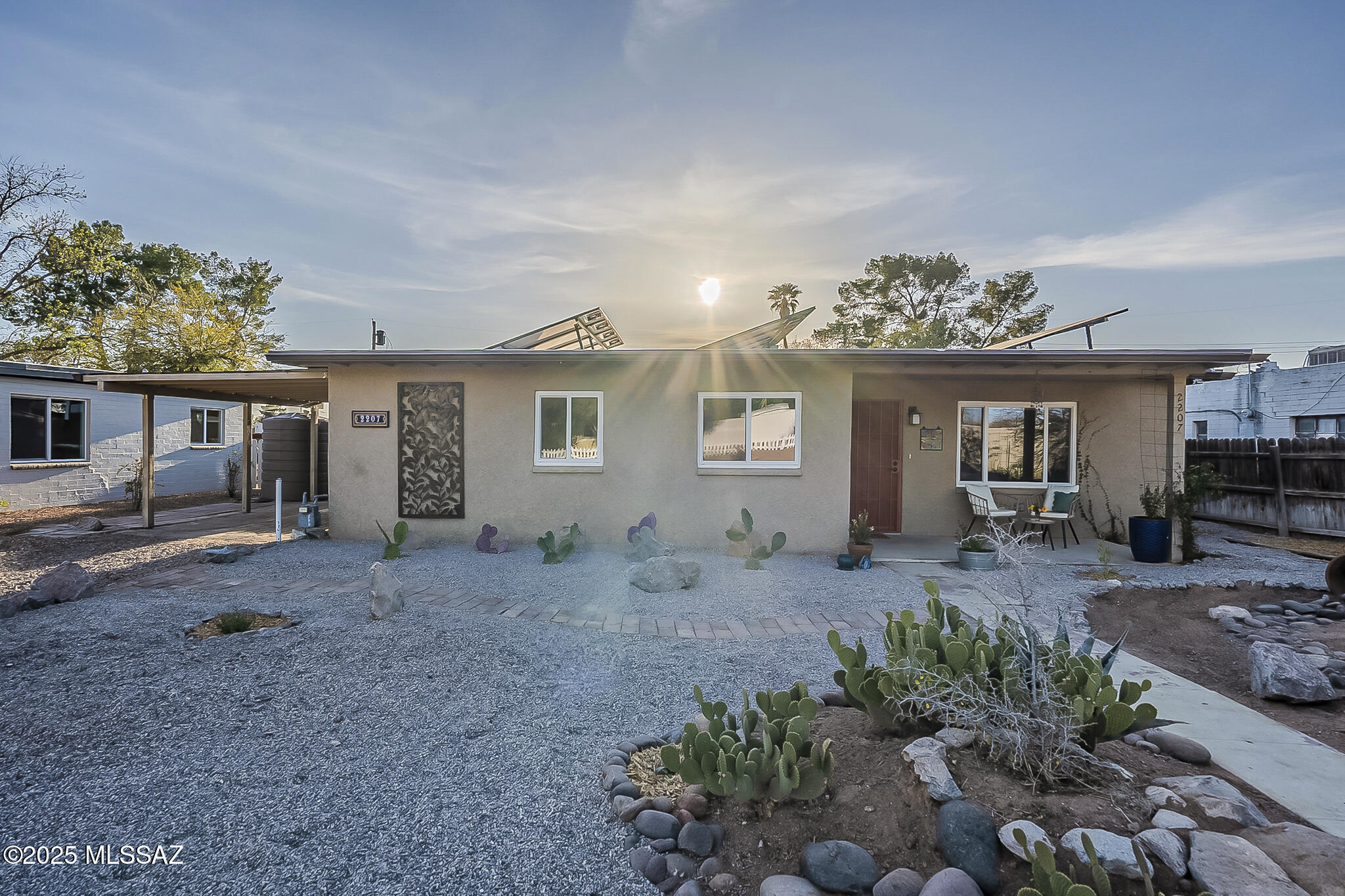 This house features a spacious layout with ample natural light throughout. The home boasts a charming landscaped exterior with a covered patio and a spacious backyard, providing a scenic and inviting outdoor space. The interior showcases a modern and neutral color palette, creating a clam and welcoming ambiance. The kitchen is equipped with modern appliances and ample countertops space, offering a functional and efficient cooking environment. The home also features environmentally conscious upgrades including owned solar, rain harvesting tanks, induction stove, electric vehicle charger and gray water system. The overall layout of the house promotes a sense of openness and flow with a spacious feel accentuated by the abundant natural light streaming in through the windows.