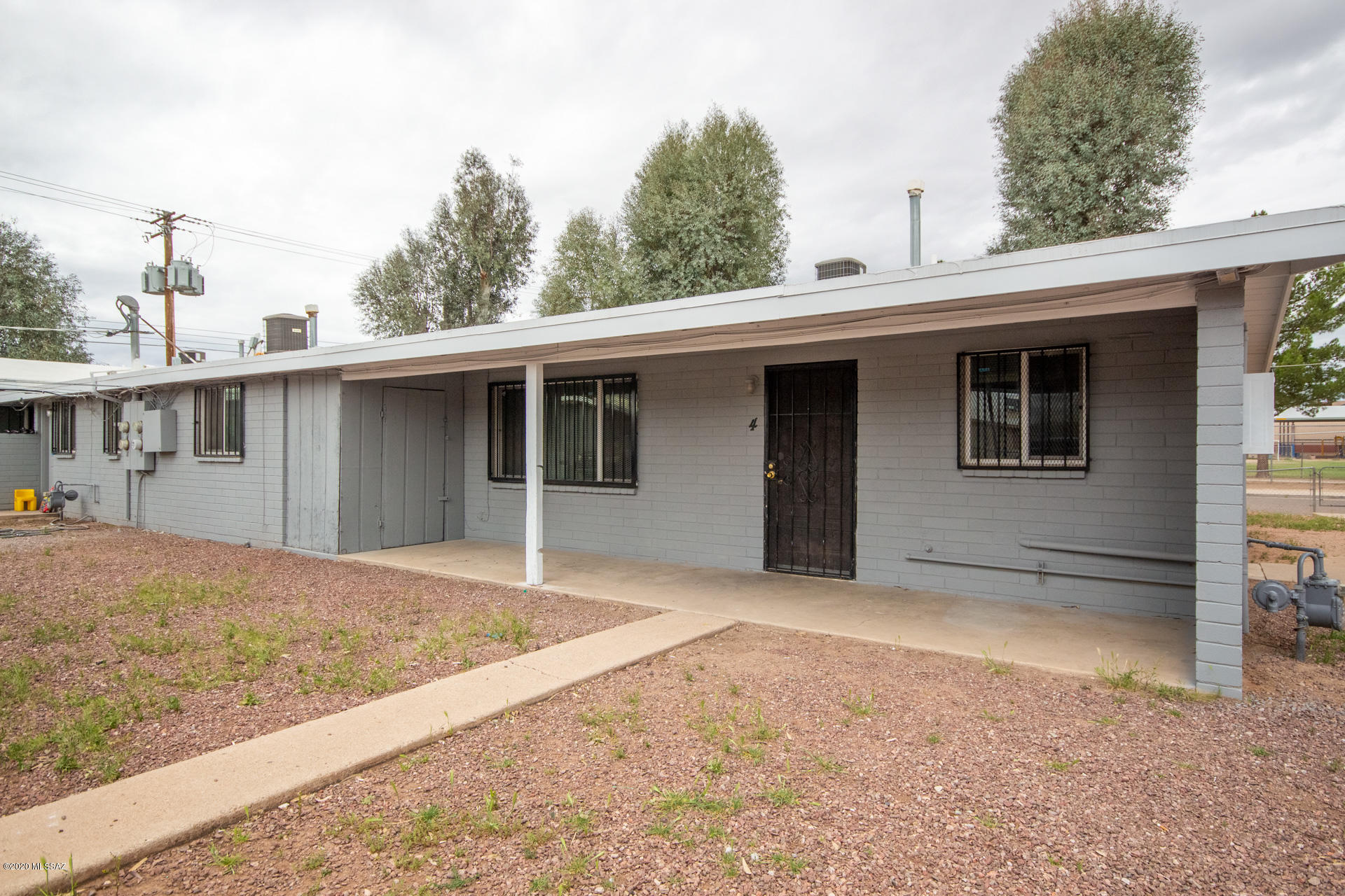Excellent opportunity to own a four-plex in the heart of Tucson. Desirable central location on a huge corner lot, close to the I-10, shopping, restaurants, and less than 5 miles from the UofA and downtown. Spacious, open floor-plans with vaulted ceilings, gas cooking, neutral paint tones, tile flooring and more. 4 covered carport spaces and additional parking on property. Large community laundry room. Nice outdoor space offering mature shade trees and beautiful mountain views. Perfect for long term or short term rentals. Live in one, rent the others. Lots of possibilities and amazing potential for income. This rare gem will sell in a flash. Hurry and see it today.