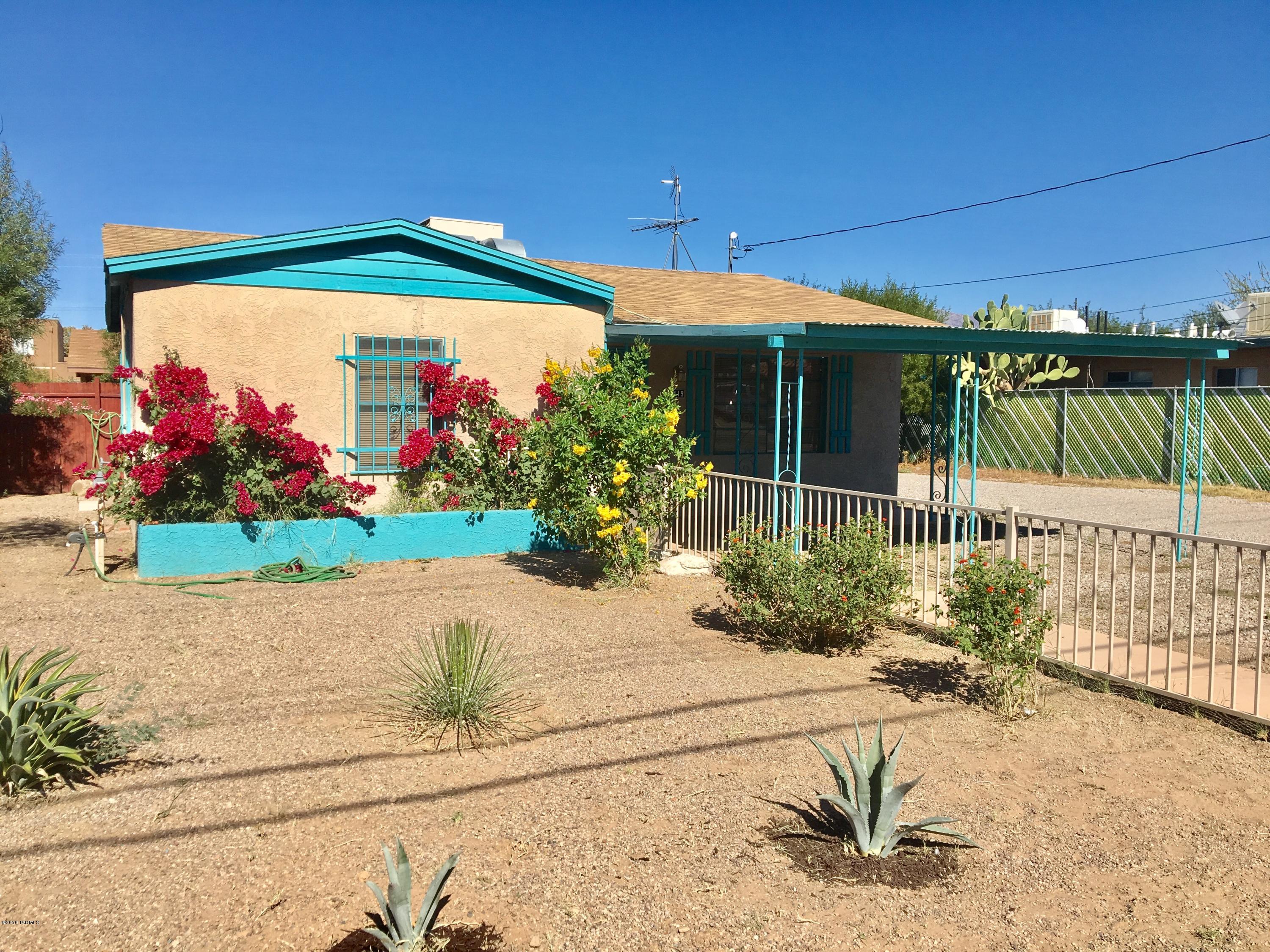 Great Bungalow near U of A! Enclosed front & rear yards, low car landscaping. Ceramic tile throughout, updated kitchen with gas stove, Large laundry room with room for storage, bikes, etc. One covered parking space with room for 2 more vehicles off street. Includes all appliances!