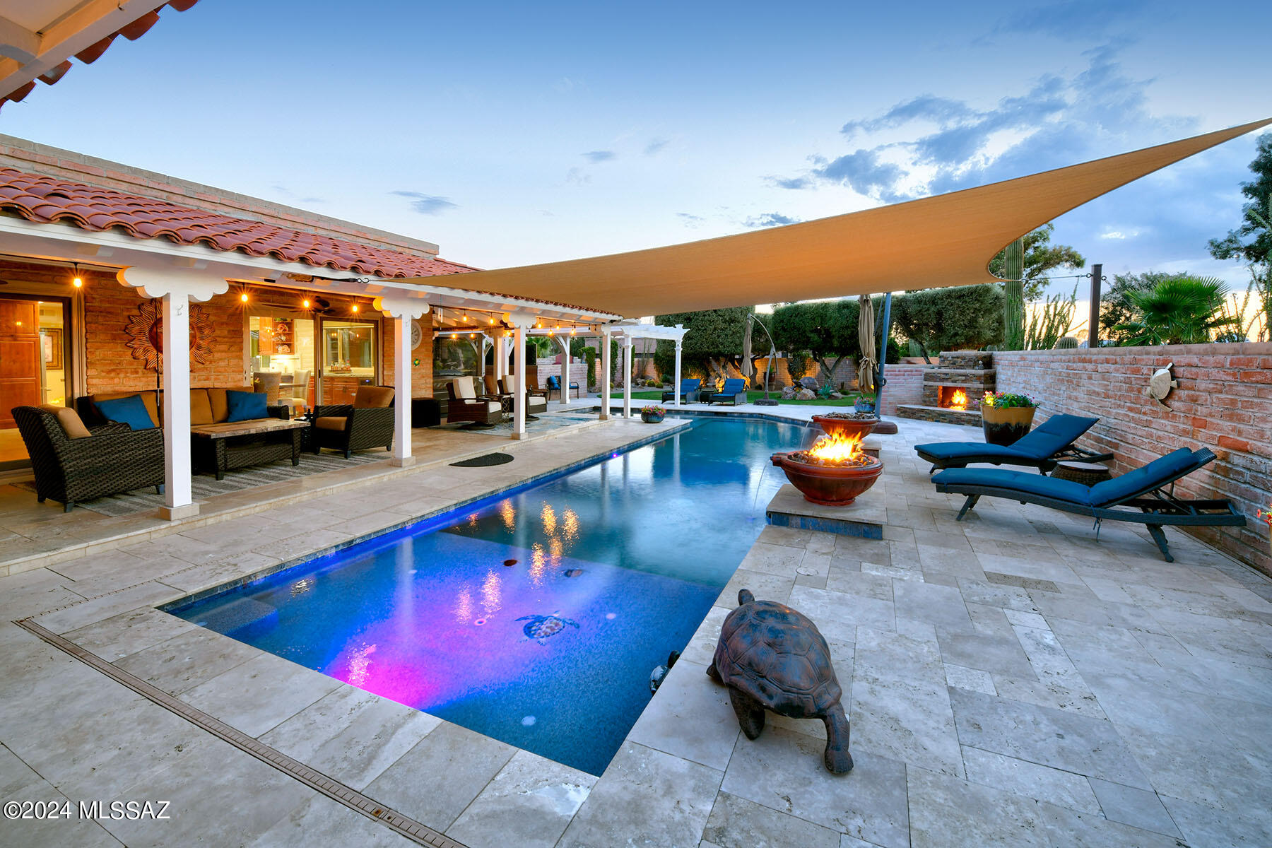 Stunning & elegantly remodeled gracious burnt adobe on the 15th fairway of the Catalina golf course in prestigious Omni Tucson National. Your welcomed in with a beautiful Wrought iron front
entry gate. Exquisite open concept Great room with a stacked stone fireplace, 18'' travertine tile floors throughout, Oversized gourmet kitchen, knotty Alder cabinets with a sensational 13-foot-long chiseled edge quartz countertop island, top of the line stainless appliances, including a
commercial grade Z Line gas range with 6 burners, griddle, & double ovens. dining area with dual zoned wine cooler, Home is equipped with surround sound throughout, 3 Bedrooms & 3 full Baths, including master with a stacked stone floor to ceiling fireplace, luxurious spa like master bath with quartz countertops, double sinks, jacuzzi tub, large double headed shower with custom tile design. Very large master closet with built in shelving and shoe racks. From your private entry you enter a
fabulous backyard paradise which features a spa and a new L shaped, heated, saltwater pebble tec pool, with 2 waterfalls and built in firepots all covered with a custom 20' x 20' sunshade over the pool. 3 car garage with epoxy floors and small workshop area. Circular paved driveway, Covered wrap around Patios, grass yard, mature trees, mountain, golf course and sunset views.
Omni Tucson National Resort extends a membership discount to individuals who purchase property here. Information is available from the Omni membership office.