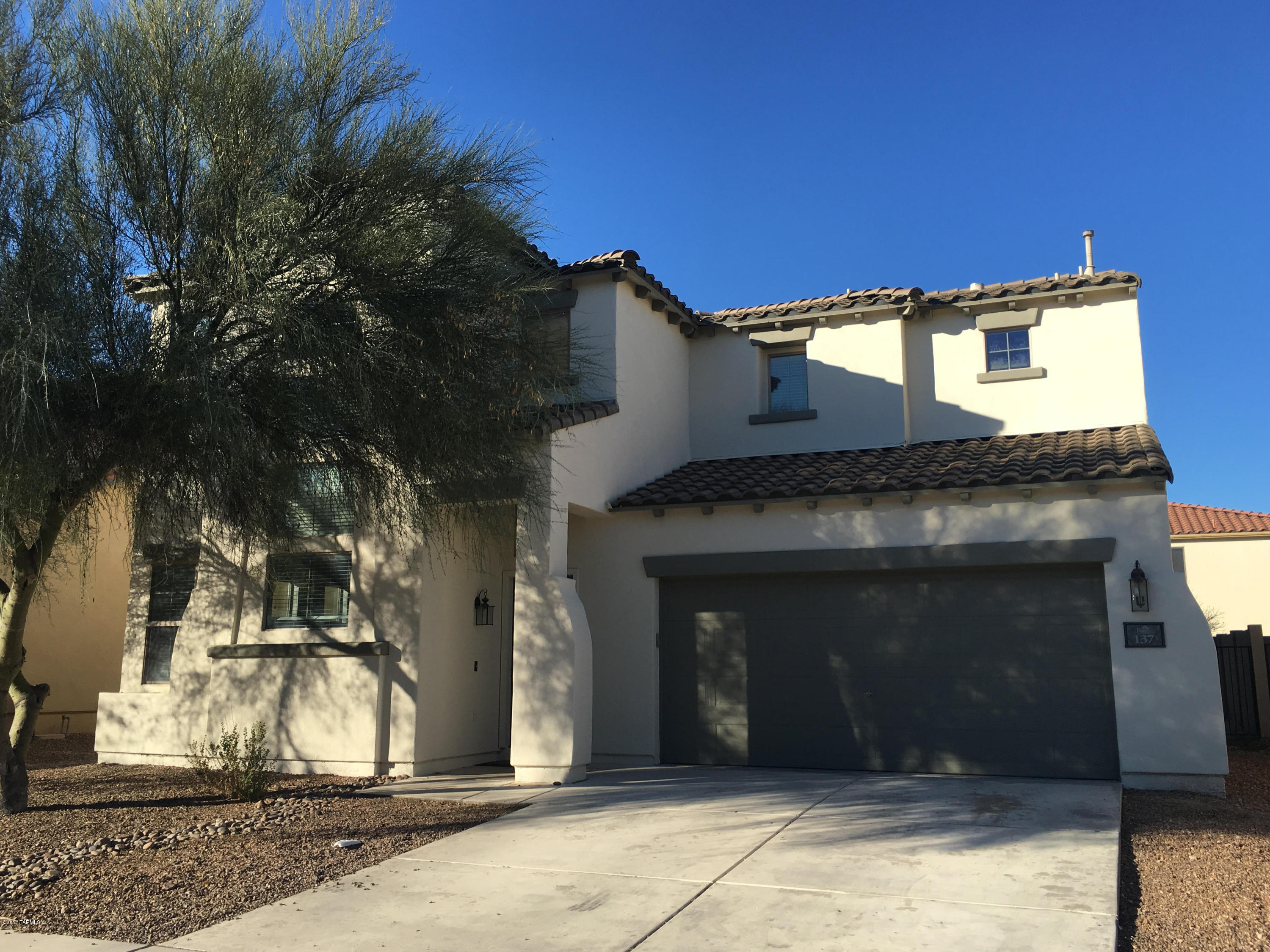 Starting with a very desirable location in the popular community of Rancho Sahuarita that offers a full club house with state of the art workout facility, multiple pools including a huge water park and even a putt-putt course. The home itself is a charming 4 bed/3 bath that shows pride in ownership throughout. Featuring large kitchen w/ breakfast bar, upgraded flooring, vaulted ceilings, and ceiling fans through out. Plus 1 bedroom and full bath located on 1st floor. Easy care backyard and located close to neighborhood park. 
New exterior paint 2016. Move in ready and truly a must see!!