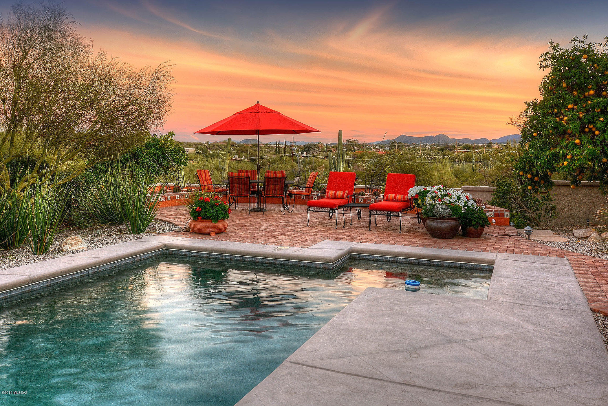 This Territorial Style stunner was tastefully updated in 2017. Situated on a desirable 3.37 acre view lot in the prestigious Tucson Mountain Reserve Gated Community, this home boasts 4 Bed/3 Bath w/ 3 car garage. Impressive paver circle driveway leads to a gated courtyard entry, into a formal living/dining room w/ expansive views of the Catalina Mtns.  
Stunning kitchen comprised of quartz countertops, subway tile backsplash, stainless steel appliances, & expansive 12 ft island butcher block w/ prep sink & breakfast nook that overlooks the cozy family room w/ gas fireplace. Retreat to the Master Suite w/ gas fireplace & newly updated spa-like bath w/ dual sink vanities, walk-in carrara marble tiled shower & jetted corner tub. New 6x36 walnut tile plank floors throughout & custom wainscoting for architectural interest. Enjoy the outdoor living from the professionally landscaped entertainers backyard w/ expansive scored concrete covered patio, pebble tec pool/spa, water feature, & extended brick patios for dining and pool lounging. Impressive city and mountain views from every room & close access to I-10 & downtown.