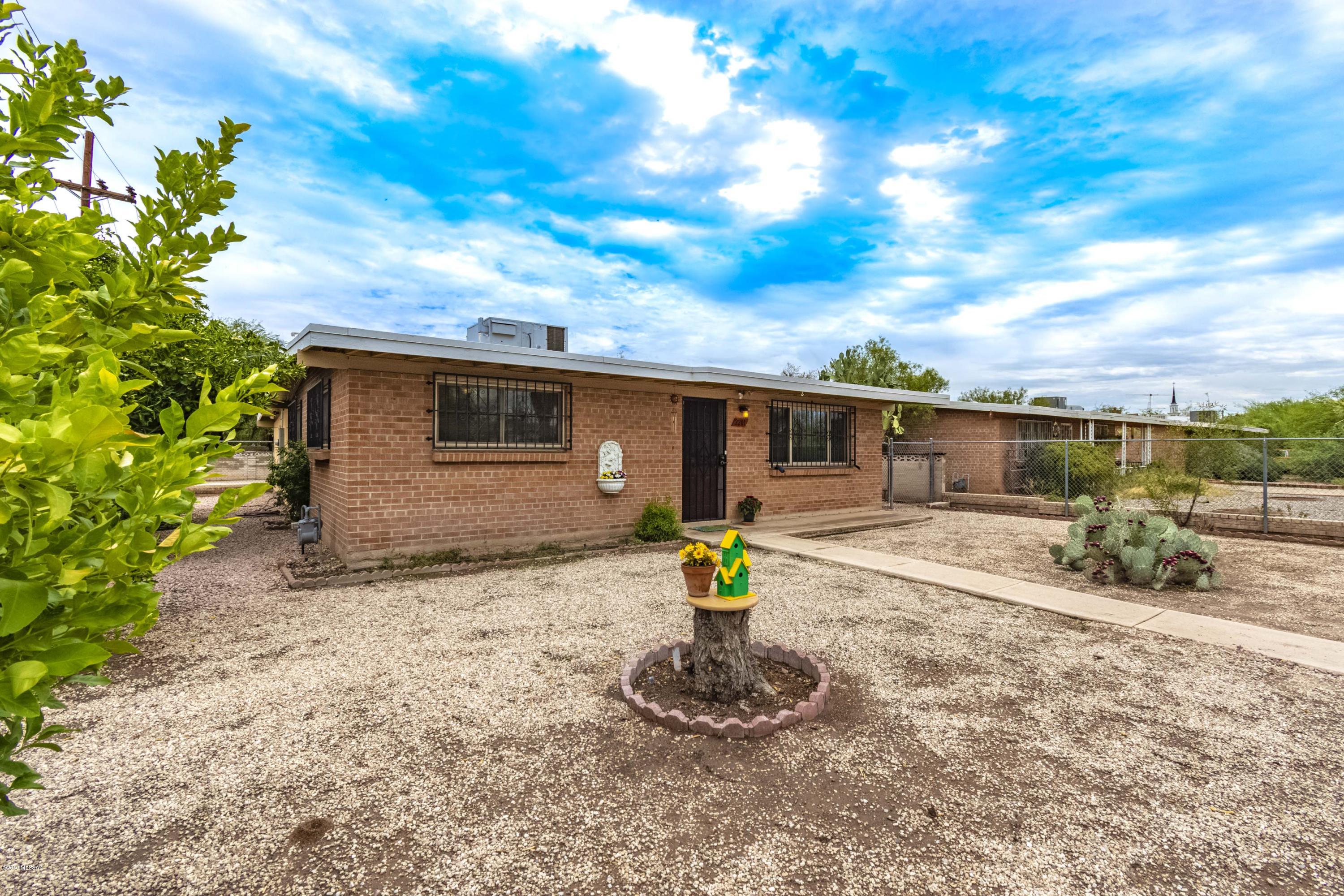 Well built brick home with many recent improvements including: new roof (w/warranty), paint, carpet, laminate flooring, new electrical service and front door. 3 bedrooms + office/den, eat in kitchen, large laundry/utility room. Loads of on site parking, 2 storage sheds, perfect for owner occupant or rental. Close to U of A, University / Banner Medical Center, shopping, bus lines, restaurants galore - within close proximity. Floor plan in documents. Very Motivated Sellers