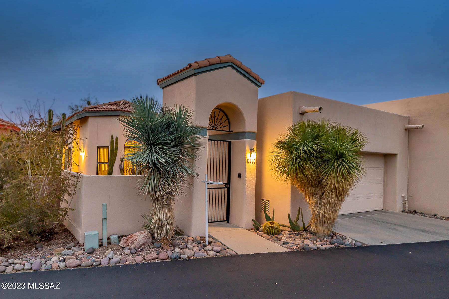 This impeccably maintained townhome located in the highly desirable gated community of Kachina Hills is move in ready!  Enter through a gated private courtyard landscaped with low care desert vegetation with access to atrium.  The property boasts a range of luxurious amenities, including functional floor plan with vaulted ceilings, natural light, skylights,  plank style tile flooring throughout central vac & access to a community pool & spa. Primary bath features double vanity, soaking tub & separate shower.  The kitchen is equipped w/top-of-the-line GE Profile SS appliances, double sink,  granite countertops & tile backsplash.  The family room showcases a gas  stack stone fireplace w/door to  patio to enjoy views of the Catalina Mountains.  Just minuets away from shopping, golf & dining.