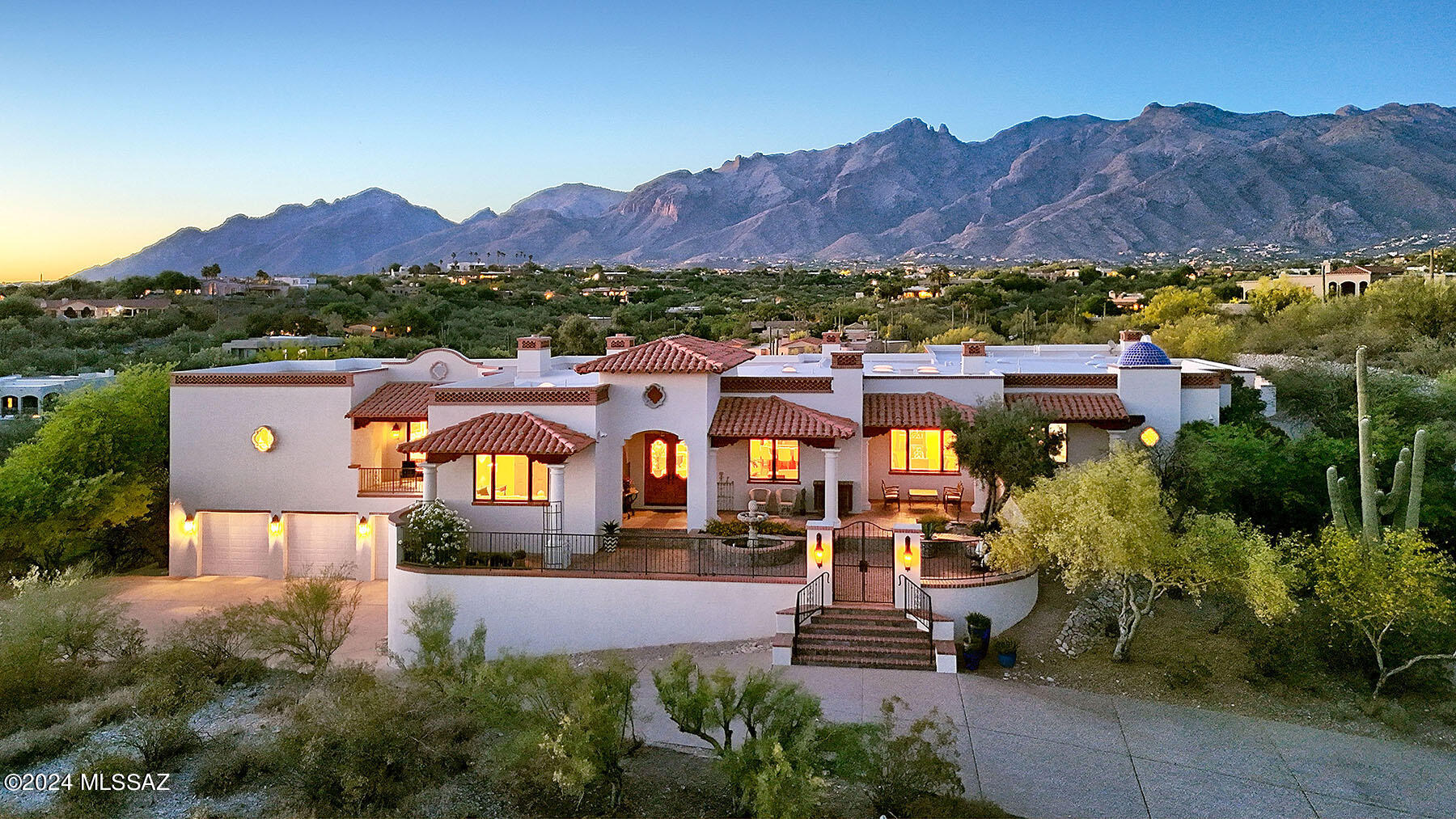 Spectacular all masonry Spanish Colonial crafted by master builder Mike Wachs as his own personal residence in the exclusive gated La Puerta on Hacienda del Sol. Marvelous views of mountains, sunsets and city from this hilltop estate custom-built with the finest materials including hand-carved beams & corbels, hardwood floors, solid wood doors, 7 fireplaces, 5-car garage, entertainer's kitchen, library/home office with floor-to-ceiling wood bookshelves, wet bar, separate guest house, & wood windows that frame views from all corridors. Masonry-stucco construction with charming brick cap and phenomenal landscaping w/extensive pavers, outdoor living & dining spaces, gorgeous pool & spa and jaw-dropping views. Sale includes additional 2.3 acre buildable lot that also enjoys sweeping views!!