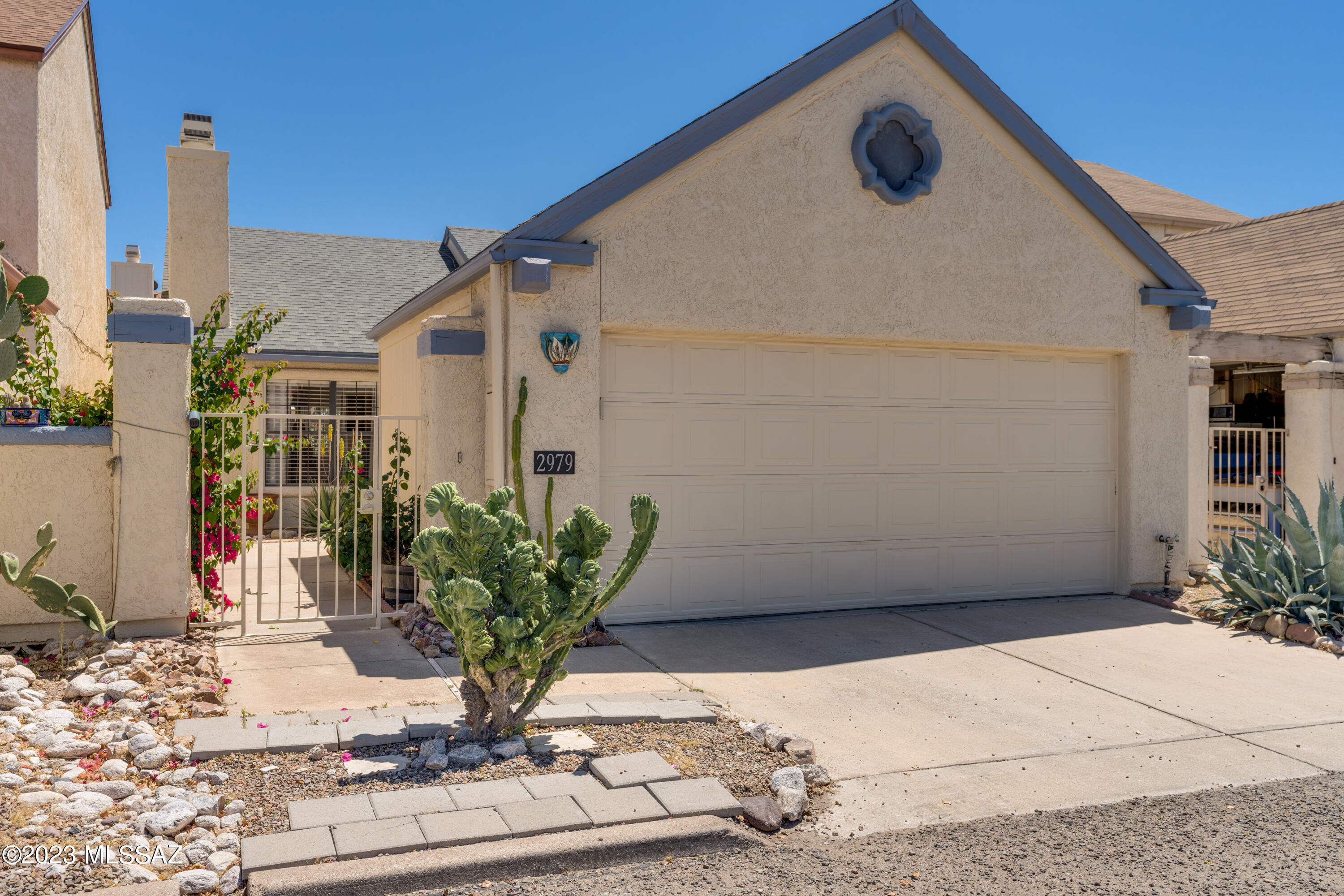 This charming home offers 2 bedrooms  (extra sink area). New Heater & AC 2023 & New appliances in 2021.  Gated front courtyard provides privacy and security. The backyard offers a nice shaded patio to entertain or enjoy quiet mornings on the patio. 2 car garage plus bonus room to be used for storage or a small workshop. The cozy living room offers a wood burning fire place, perfect for chilly winters. In the kitchen you will find a generous size pantry plus a sliding door leading you to the back patio perfect for entertaining. Split bedroom plan. Walking distance to the pool, park, mail & guest parking. This home has it all! *No polybutylene pipes.