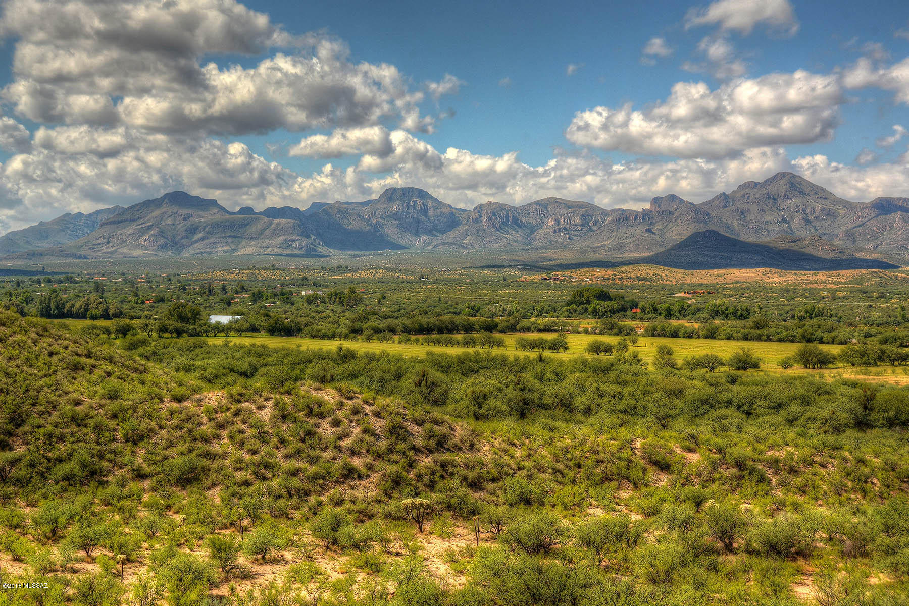 Beautiful 1232.92 acre So. Az. ranch with both level irrigated and high desert pastures, paved entry roads, a stunning 1930's era adobe main home/grounds, approx. 1838 ft of I-19 frontage road, all straddling approx. 1.2 miles of the Santa Cruz River near Tubac Golf Resort. 1359.5
acre/feet of IGFR water rights (145 of 312 acres currently irrigated from 2 primary irrigation
wells). Stunning masonry/stucco entry wall, mature trees & irrigated lawns circle 6484 sq/ft,
7BR, 4.5BA main home w/tiled roofs, hardwood floors, basement, hacienda patios (surrounding pool), private pond. Detached 4 car garage, guest and caretaker houses. Farm & ranch
equipment available. Adobe barn w/metal roof, shop, outbuildings. A classic Santa Cruz River ranch just 38 miles S. of Tucson.