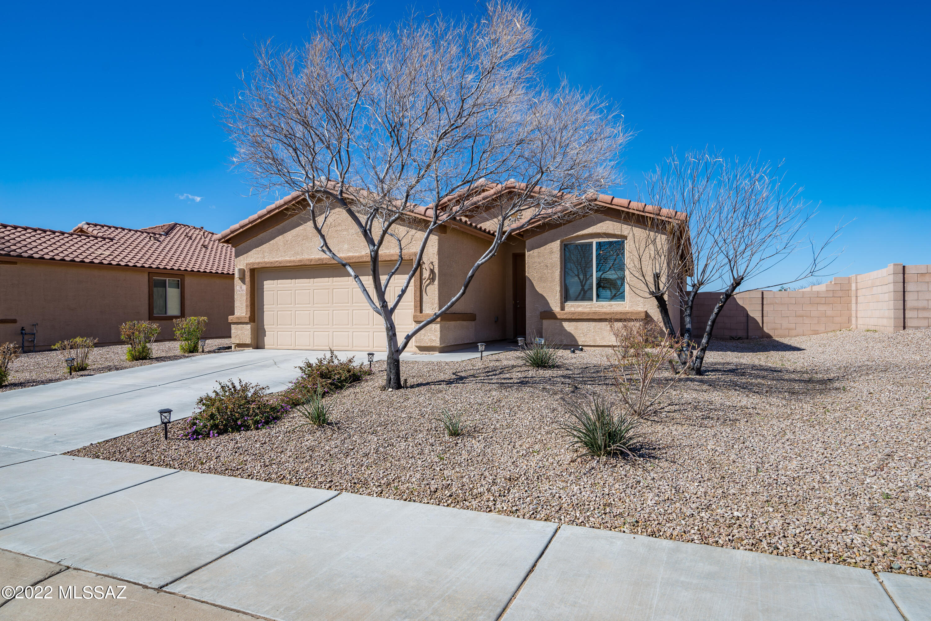 Lovely Home in Great Growing Northwest Marana.  Original Owners, 2013 Build. Split Bedrooms – 3 Beds/2 Baths/2 Car Garage – 1789 Sq Ft. Quiet neighborhood, sidewalks & parks. Open Concept: casual dining, great kitchen w/cherry stained cabinets, gas stove, good storage & counters, eat up bar. Large living room adjacent to kitchen. 18'' ceramic floor in public are - carpet in bedrooms.  4 ceiling fans, wood blinds, niches and canned lighting. Walk-in pantry, laundry room w/ shelves & coat closet.  Dual sinks in master bath & shower only.  Full guest bath.  Smoke detectors in bedrooms. Large side yards, homes in back not close.  Conveniently located to I-10 - Easy to downtown Tucson or up to Phoenix!