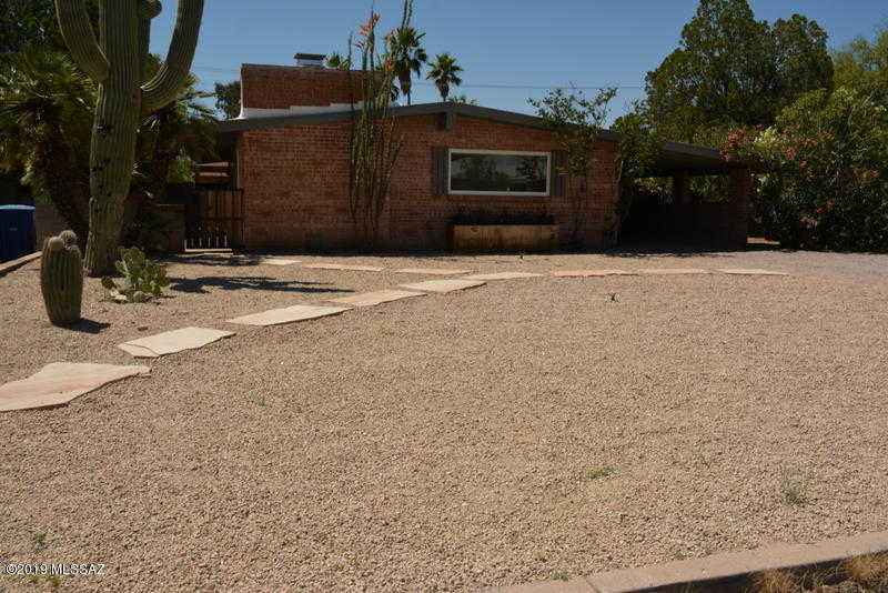 Remodeled beautiful brick home charmer in the coveted historic Poet Square neighborhood.  3 Bedroom 2 Bath with wood flooring.  Fresh paint throughout the interior as well as the exterior.  Completely landscaped with 2 large pavered patios that are great for entertaining. Enjoy the views of the Catalina Mountains. This home has air conditioning along with a beautiful wood burning fireplace.  Tons of privacy with a recently installed block surrounding the perimeter of the yard. This yard has plenty of room for a refreshing pool and great outside entertaining.  Close in proximity to everything.  The seller will  provide a $3000 concession to be used towards a new kitchen dishwasher and new stove kitchen appliance. Please Escrow with Title Security Agency - Ronda Tatro.
