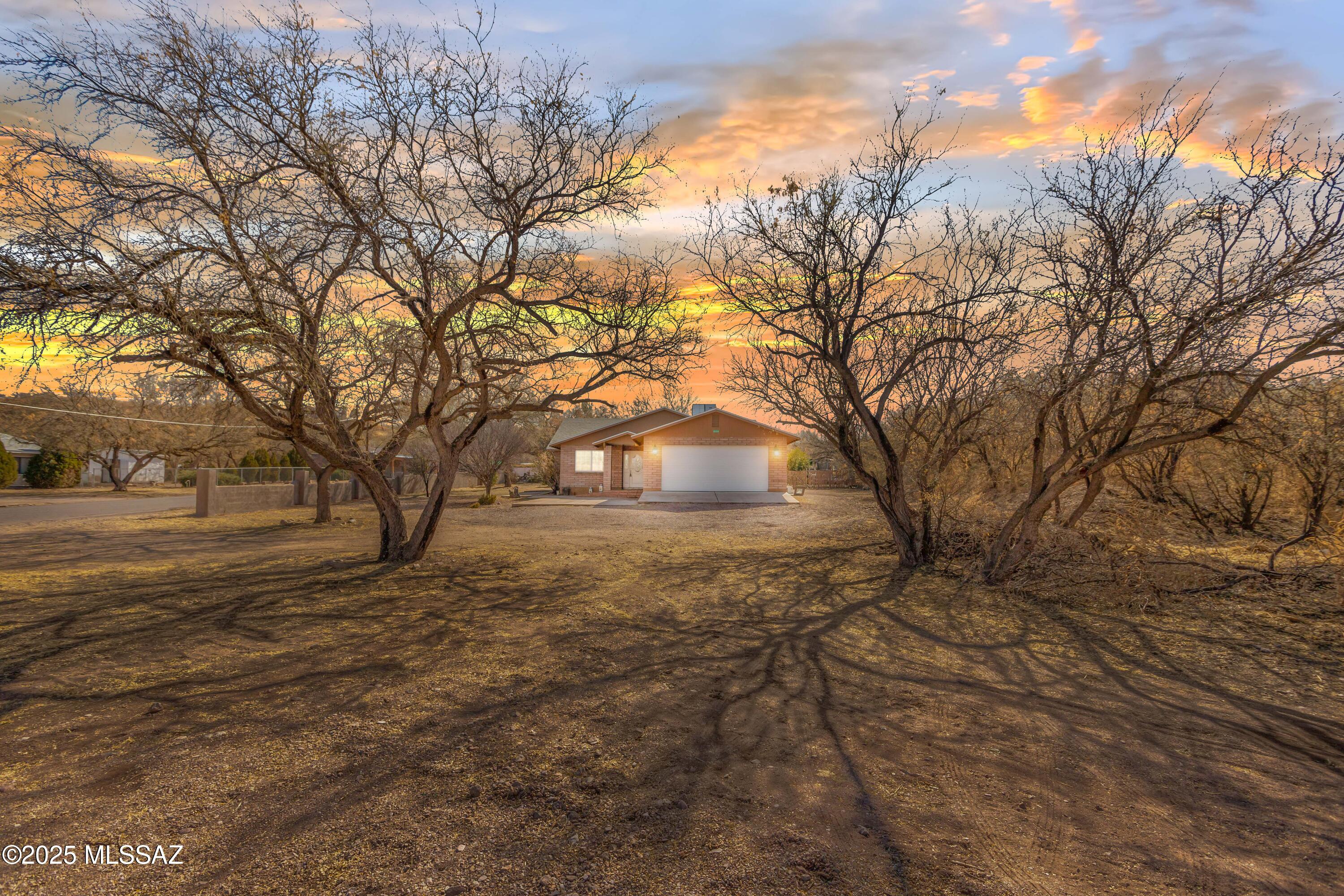 Seller will consider/counter offers between 275k-285k. Check out this wonderfully maintained ranch style brick home in the Rio Rico estates neighborhood. Boasting a large corner lot, with plenty of privacy, NO HOA, and in nearly .6 acres. This 3 bedroom 2 full bath home, has a spacious open floor plan with vaulted ceilings, central A/C unit, 2 car garage, large den/office room, and ceramic flooring throughout. The kitchen is stunning with natural wood cabinetry, eat-in peninsula island, stone backsplash, and a large pantry. The primary room is an extended length, has dual fans, windows galore, and a walk-in closet. It also has its own en suite bathroom with walk in shower, floor to ceiling tile, and a soaking tub to relax in.. Enjoy the covered patio area with lighting and ceramic tile. Also, the beautiful sunrise and rolling hills views nearby. This homes is only minutes away from a the Rio Rico Plaza, a park, and the freeway. Come see this beauty for yourself!
