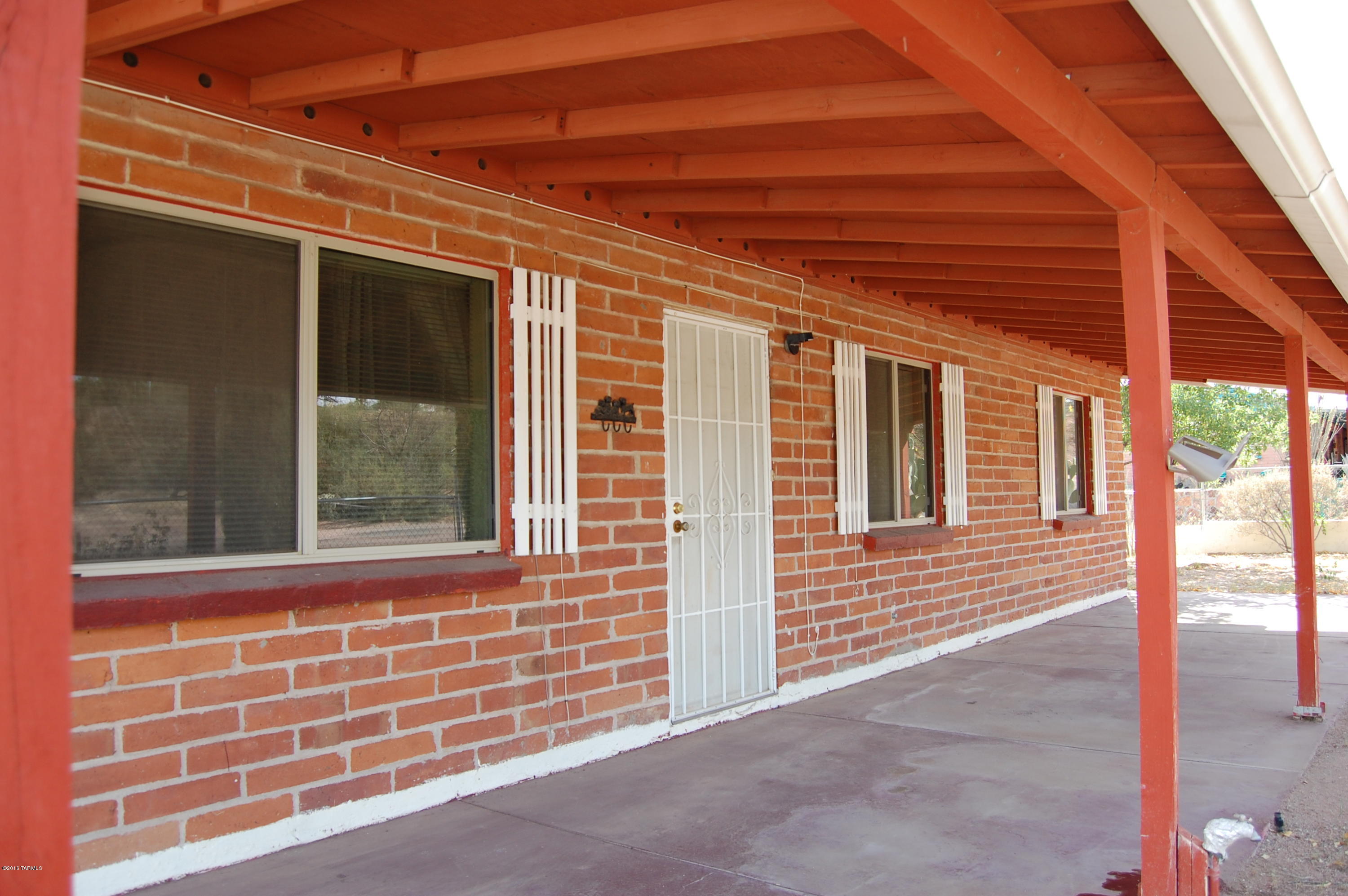 Well maintained home with many features including ceiling fans in bedrooms, dining area and living room, fire place in living area, covered porch in front and back yard and covered RV parking.