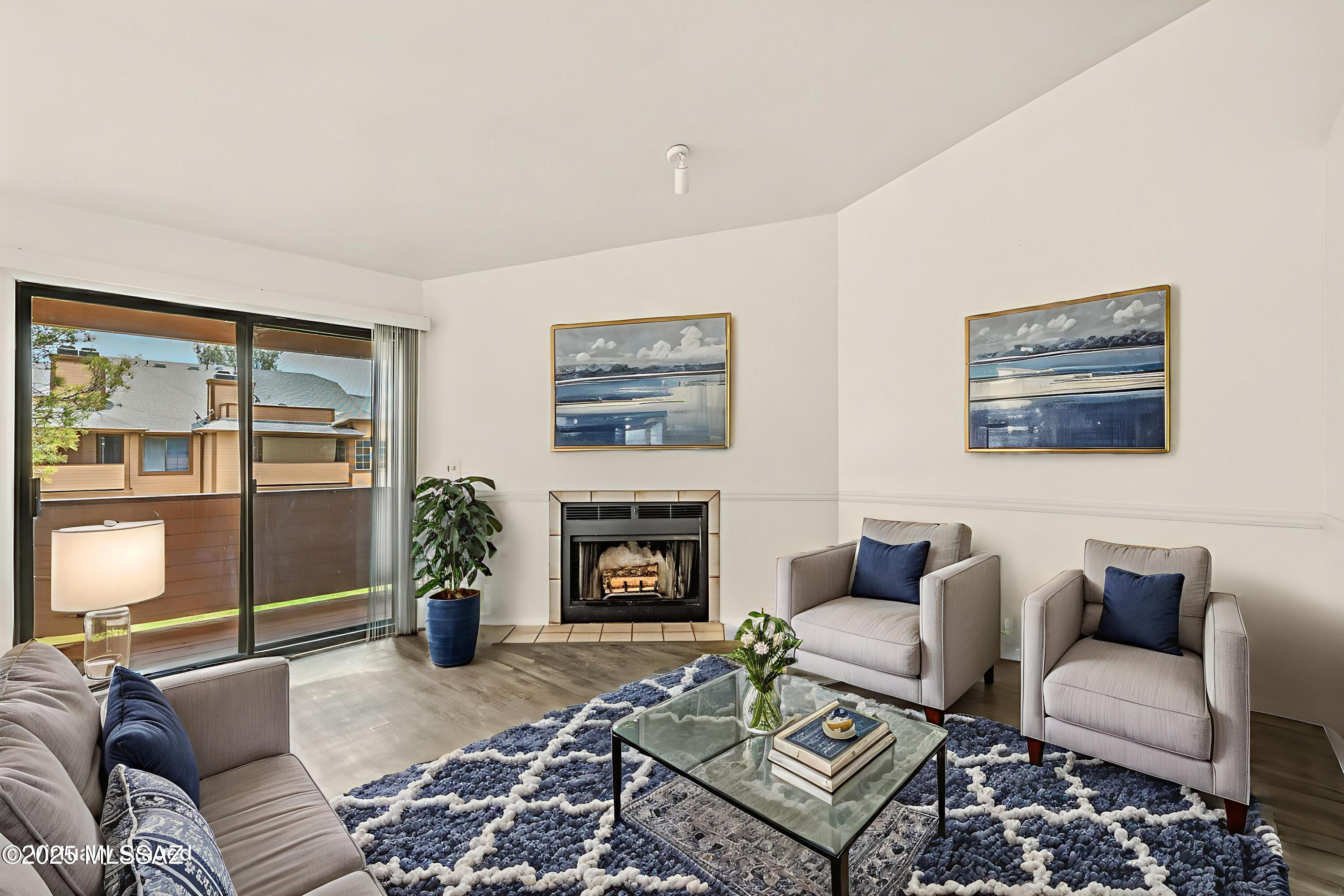 Located in southwest Tucson, this well-maintained condo offers a spacious open-concept layout with a cozy fireplace in the living area. The dining space features scenic window views of the grassy common area and connects to a bright kitchen with ample lighting and a generous pantry. A private balcony with wood beam flooring and extra storage enhances outdoor living. This larger unit includes 3 bedrooms and 2 bathrooms, recently updated with fresh paint, new carpet,  a newer AC less than 4 years old and brand-new tiled showers.