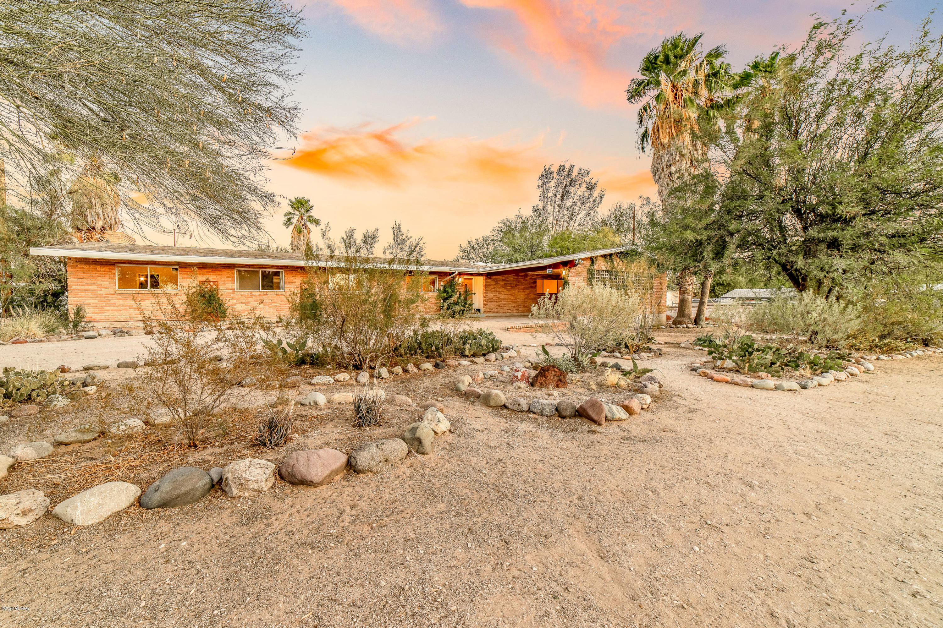 Well maintained & charming ranch home in desirable Sam Hughes neighborhood on a large .42 acre double lot. This original owner 4 BD/2 BA/2,619 Sq.Ft red brick home is walking distance to Himmel Park, UofA, schools, restaurants & much more.  Inviting floorplan offers a living & dining area, family room w/fireplace, den & plenty of storage. Kitchen has corian counters, plenty of cabinets & casual dining space. Master suite is large w/a walk-in closet, shower & vanity. Backyard offers a full length covered patio, mature vegetation, 2 sheds & possibility to add a 2nd home. Wonderful opportunity to own a home in Sam Hughes with great history & location.