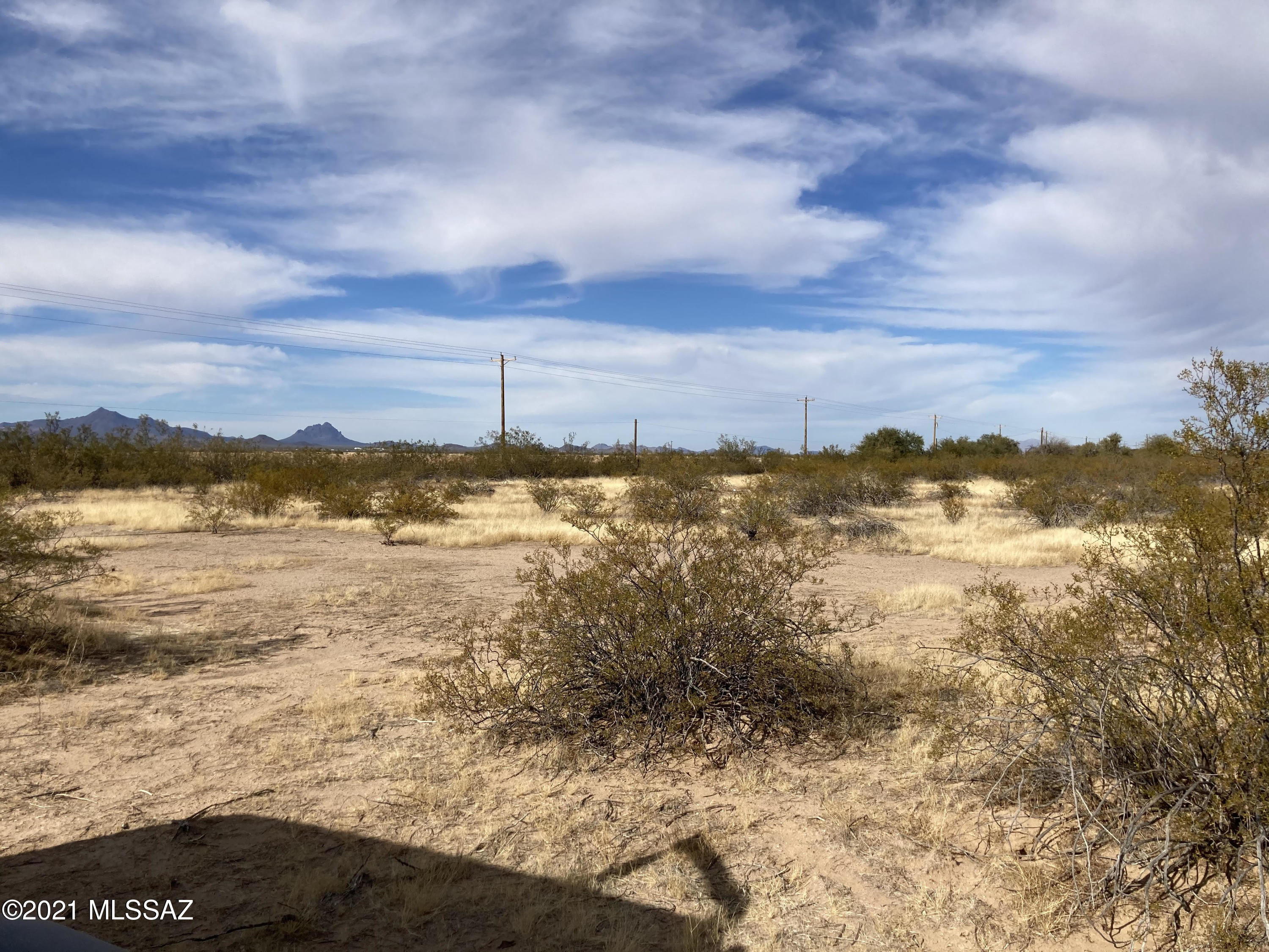 Clean 5+ acres - original desert brush - on paved road - perfect for new home or whatever your needs