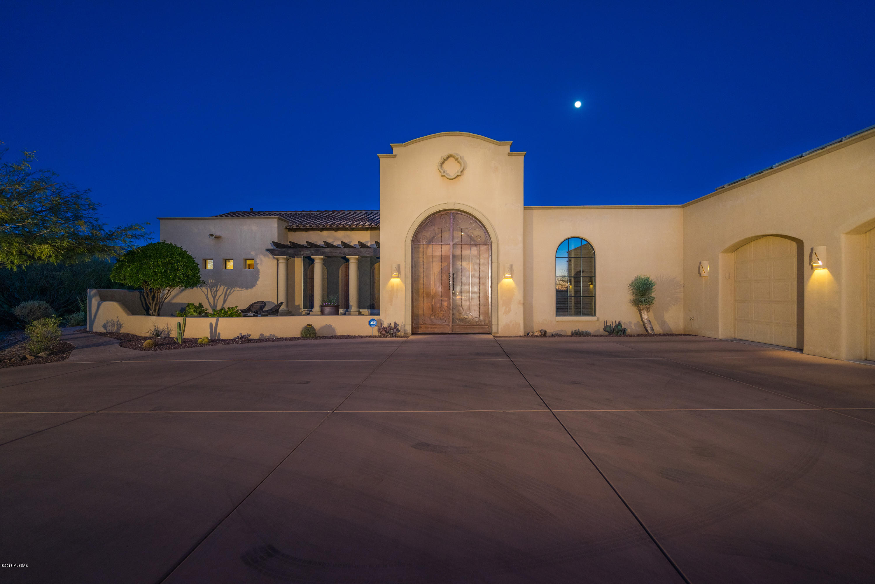 Be amazed by this creation from custom home builder Chris Kent. This exquisite home is thoughtfully situated to capture the majesty of the Rincons from inside and out. Attention to detail is an understatement, from intricate tray ceilings, arched windows w/ wood frames to 12-foot wrought iron/metal entry gate. Massive remodel completed 10/17. The grandeur of the living room is illuminated by natural light and punctuated by an impressive decorative concrete fireplace. The magnificent kitchen will make you think you are a Michelin Star chef with its impressive Wolf gas cooktop, granite slab counters, substantial center island, walk-in pantry, two dishwashers and two sinks. The backyard resort-like oasis showcases multiple patios, unobstructed views, and Pebble Tec pool.