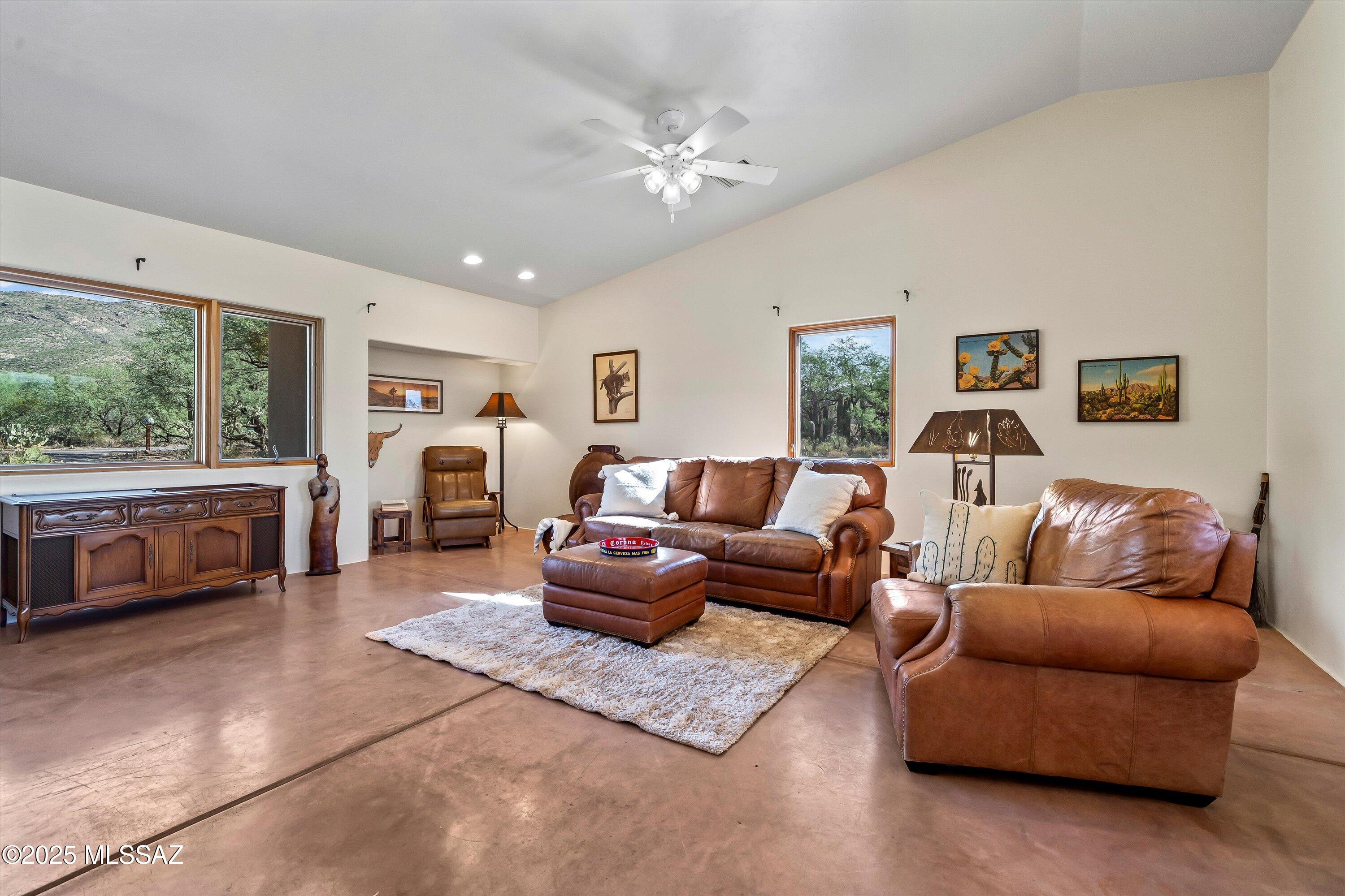 Saddle up for a lifestyle that blends wide-open freedom with modern convenience. Settled on 5 sprawling acres full of mature native and indigenous vegetation, this 2-bedroom, 2-bath retreat offers 270° mountain views that capture the spirit of the Southwest ... A panorama of sunrises, sunsets, and star-filled skies. Just five minutes from shopping, dining, and essentials, yet it feels a world apart, as if you've stepped into your own private frontier.

Inside, the home tells a story of contrast and character. The living spaces showcase retro cowboy, rugged cabin-esque charm with warm wood accents, natural textures, and timeless details. In the bedrooms, the energy softens, inviting spaces that create a restful balance, perfect for unwinding after long days under the desert sky. Cont --> Outdoors, the possibilities stretch as far as the saguaro studded horizon. Whether you dream of keeping it simple and serene or building out your own desert oasis, there's room here for imagination to roam. And speaking of roaming, enjoy the many trails from your front door. 

LOCATION LOCATION LOCATION: Unbeatable access to Agua Caliente Park, Chiva Trailhead/Falls, Tanque Verde Falls, Reddington Pass, Babad Do'ag Scenic Overlook, and so many other desert destinations in The Old Pueblo, with easy connectivity to miles of hiking, biking, and equestrian trails right from your neighborhood.  Located near the gateway to Mount Lemmon, imagine the ease of cool weather escapes, access to alpine trails, skiing and snowboarding during the winter months, and year round adventure ... including the upcoming Oktoberfest!

With the Rincon and Santa Catalina Mountains as your backdrop, serenity comes built-in, inviting you to unwind and savor the peace, beauty and tranquility of daily desert living. 

This property isn't just a home. It's a statement of independence, personality, and place. A rare opportunity to live with sweeping views, endless skies, and authentic character, all without giving up proximity to the city.

FIRST TIME ON MARKET!