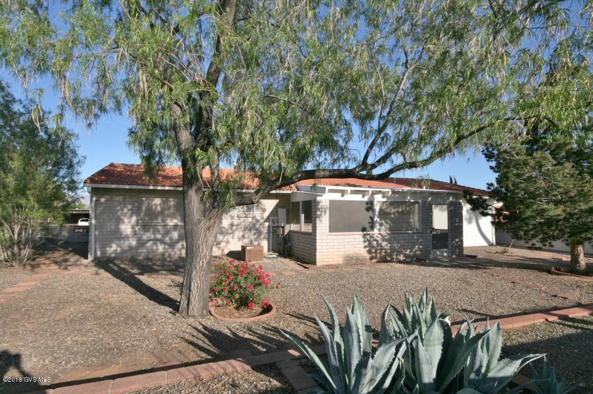 WANT A SUPER VALUE? Here it is--slump block with MTN VIEWS, a 2 CAR GARAGE w/WORKSHOP, storage & laundry. Bonus features: TILED ROOF, huge covered patio, ALL appliances, large yard with stucco/brick walls & mature shade trees. Sold as-is. Furnishings available by SBOS. One of Green Valley Rec's 13 centers is nearby with free pool, spa, exercise equipment, SPORTS, clubhouse, lectures, movies and games included with required membership. GVR also offers classes in ART, music, YOGA, dance, WOODWORK, computer, SILVERSMITH/JEWELRY MAKING, languages, BIRDING, ceramics, sculpture, etc. (See photos). Here you can add life to your years and YEARS to your LIFE with 5-STAR RESORT BENIFITS on a budget Scrooge would approve! (No sign on property. Priced AS-IS)
