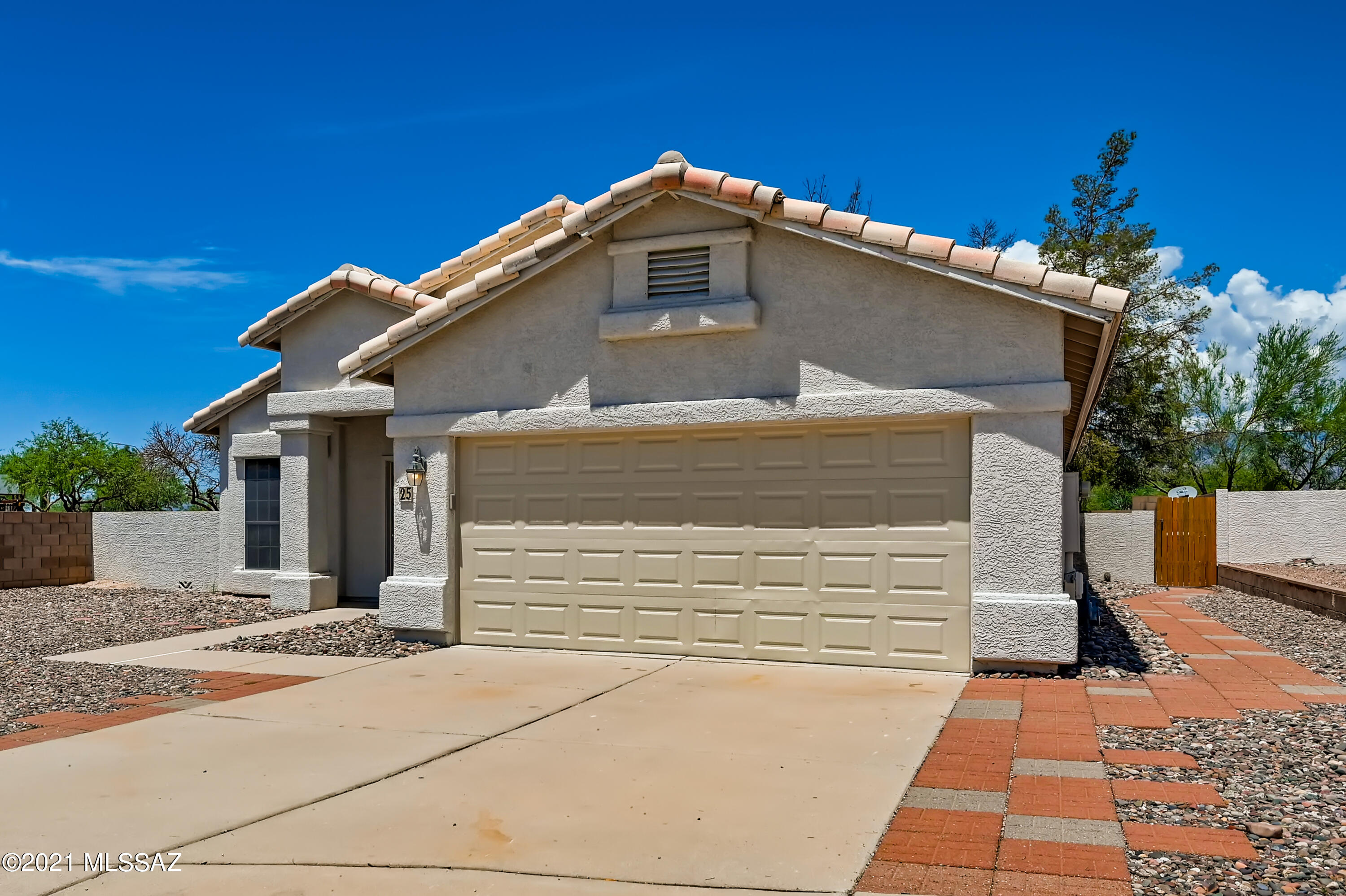 Offers will be reviewed after 8/4. Please submit your best offer by 8/4 at 11:59 pm. Come fall in love with this charming 3 bedroom, 2 bathroom home with a welcoming open layout and vaulted ceilings! The kitchen shares space in the open layout with the great room and boasts gleaming white appliances as well as an island with a breakfast bar. After a long day, retire to the primary bedroom suite which includes a walk-in closet and private bathroom with double sinks and a separate soaking tub. Looking to entertain guests? The backyard is ideal with its cool covered patio. Fantastic location close to assigned schools, groceries, dining, and just 8 minutes from Saguaro National Park East!