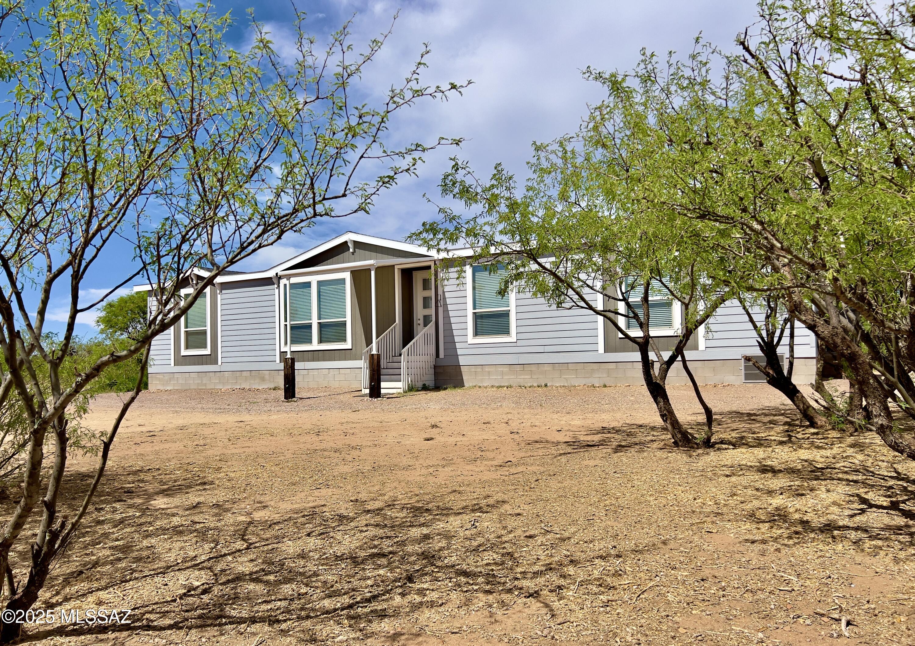 14 acre oasis nestled within mesquite trees & 20+ fruit tree orchard. Home boasts w/ upgraded features. First, let's talk about the full set GE Cafe' Smart Appliances including a double oven & warranty thru 1.2029. Additionally there's a standup freezer & separate washer/dryer. Open concept home w/ 9ft ceilings & crown molding. Natural light throughout from 6ft windows w/ cordless blinds. Within the dual gated fenced property is an open barn, detached garage & large lofted shed. Both shed & barn are fully electric & the main panel is upgraded w/ RV capabilities. Private well is equipped w/ an electric/solar pump. The property is horse approved & Loma cert. There's also a fun parkour playground & climbing wall. Last, relax by the fire pit as you unwind w/ the Arizona sunset & mountain view