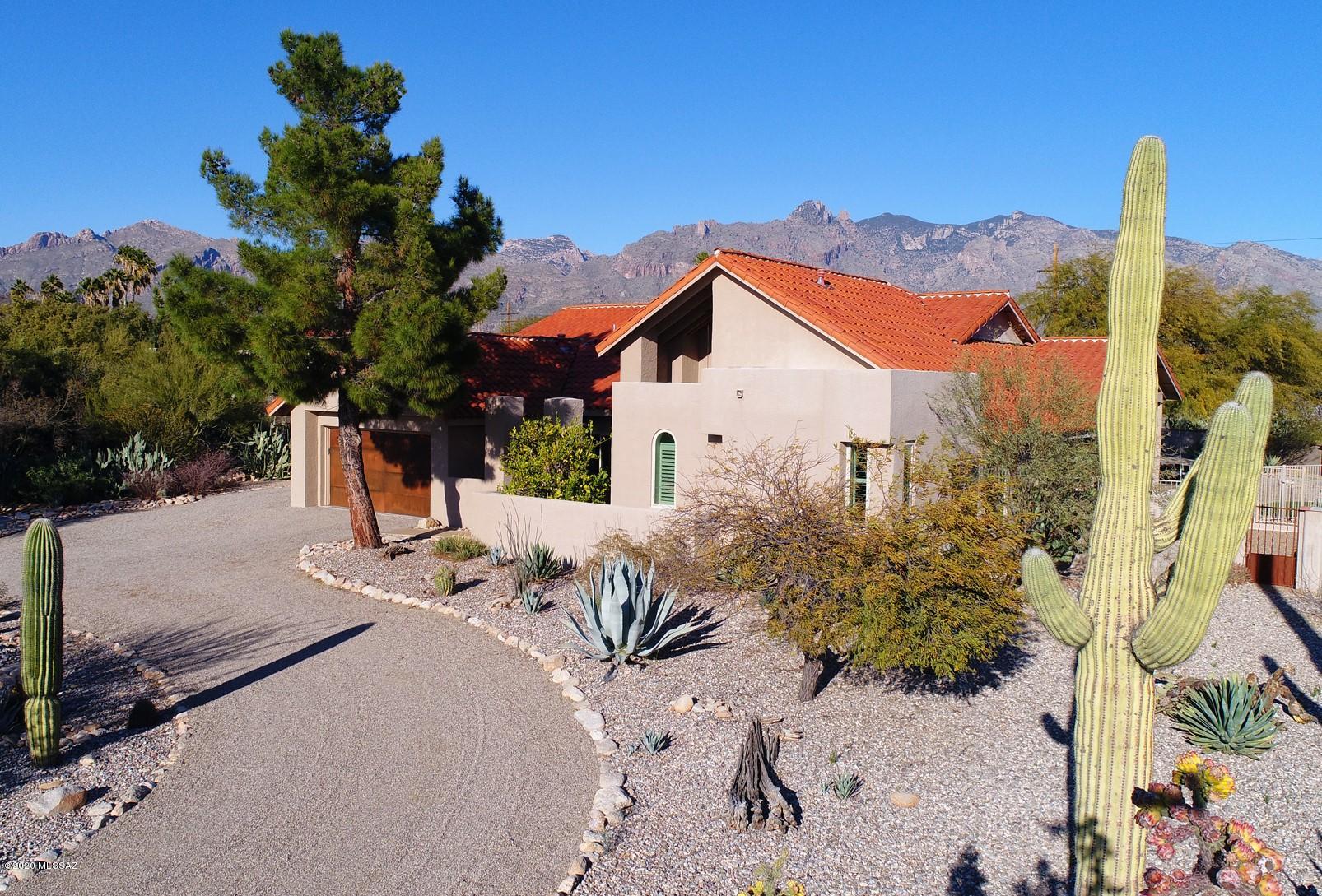 Get ready to fall in love with this southwestern home nestled in the coveted neighborhood of Shadow Hills!  This updated home greets you w/ dramatic vaulted beamed ceilings, stunning hand laid concrete floors and many architectural details.  You will want to live here!  Enjoy the open floor plan where the chef's kitchen is truly the hub of the home.  Brightened by an abundance of natural light, this home boasts breathtaking views of the Catalina mountains and comfortable spaces both inside & out.  Relax on the expansive outdoor covered patio, take a dip in your sparkling pool & entertain around your fire pit on a cool winter evening.  Nothing has been missed in this meticulously updated & maintained home.See update list.Check out the virtual tour link in photos and step into your new home!