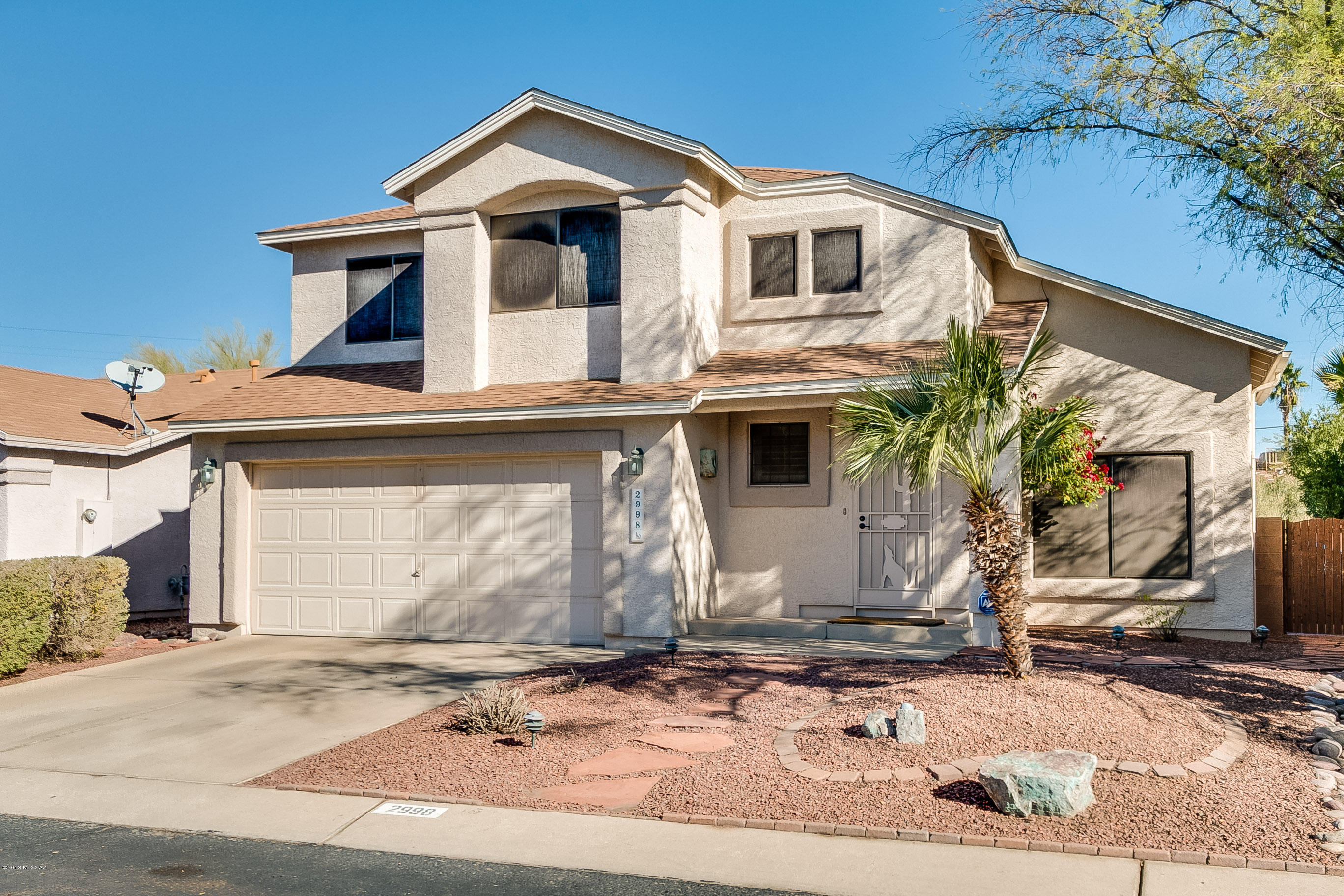 This beautiful home is in a community with a pool, backs up to a green space w/ peekaboo mountain views, has built in BBQ, water fountain, patio, pavers, etc. Inside the home are gorgeous bamboo floors in the living & dining room & stamped concrete throughout. With a wonderful floor plan, the 3 spacious rooms are upstairs, including the large master bedroom (with a spacious walk-in closet, large bath w/ newer tile floors, a garden tub & walk-in shower) & an updated guest bath. Don't forget the powder room downstairs, 2 car garage, 2 dining spaces and bright living room w/ vaulted ceilings. There are wooden plantain shutters on most windows, newer paint in the bedrooms and recently seeded grass in the back yard. HOA covers community pool, trash, recycling and common area maintenance.