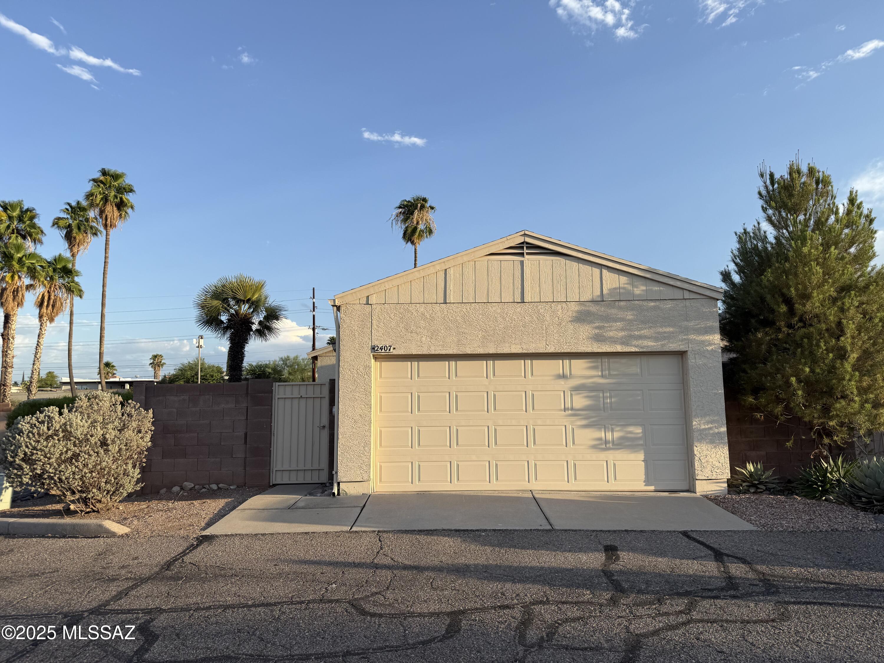 Amazing corner 3 bedroom 2 bath townhome in gated community. Close to U of A, Pima & Downtown. Largest yard in of community with upgrades such as turf, pavers, patio & extra storage closet. New paint, newer like wood flooring throughout, modern fixtures, black appliances all stay. Natural lighting, skylights and large windows with new blinds. Upgraded fixtures, Remodeled walk in shower in primary bath. Washer/Dryer stay. A/C 2 yr old, All Plumbing replaced. 2 car inclosed garage! Additional storage. Community offers community pool. Water and sewer included with HOA.